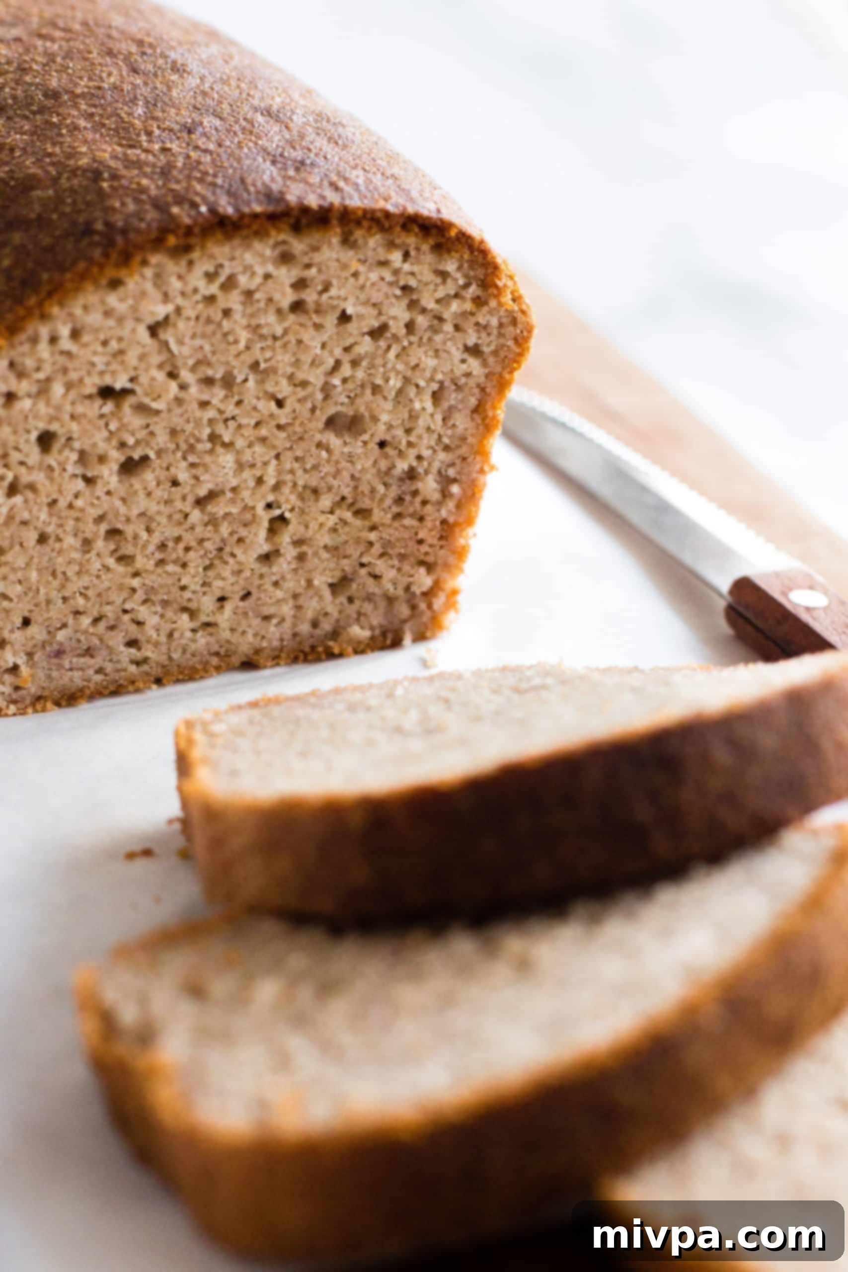 An up-close shot of the texture of the inside of a loaf of brown rice bread.