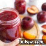 Effortless Pectin-Free Plum Jam 2 Hand reaching for plum jam
