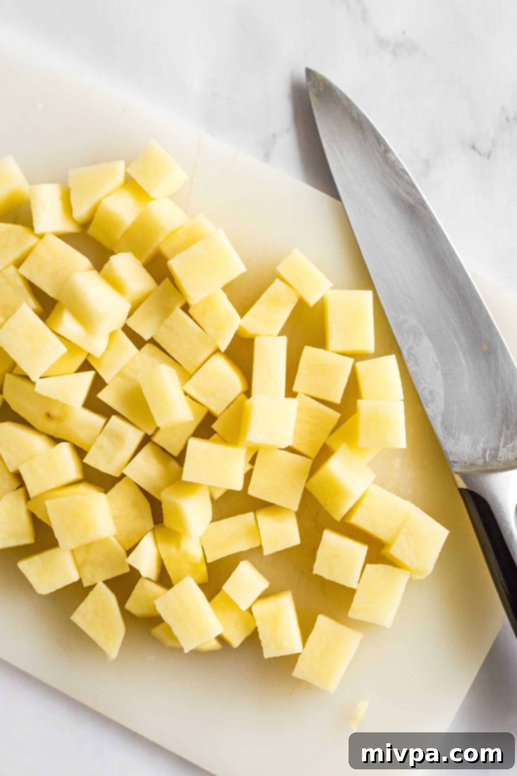 Diced potatoes on a chopping board.