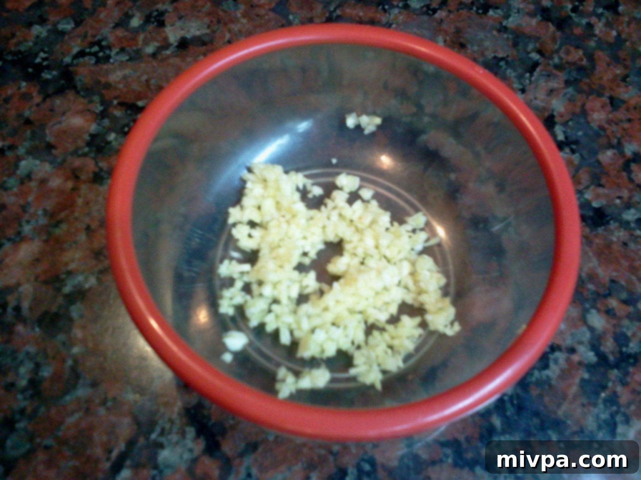 Finely minced garlic cloves, neatly arranged, prepared to be added to the risotto base.