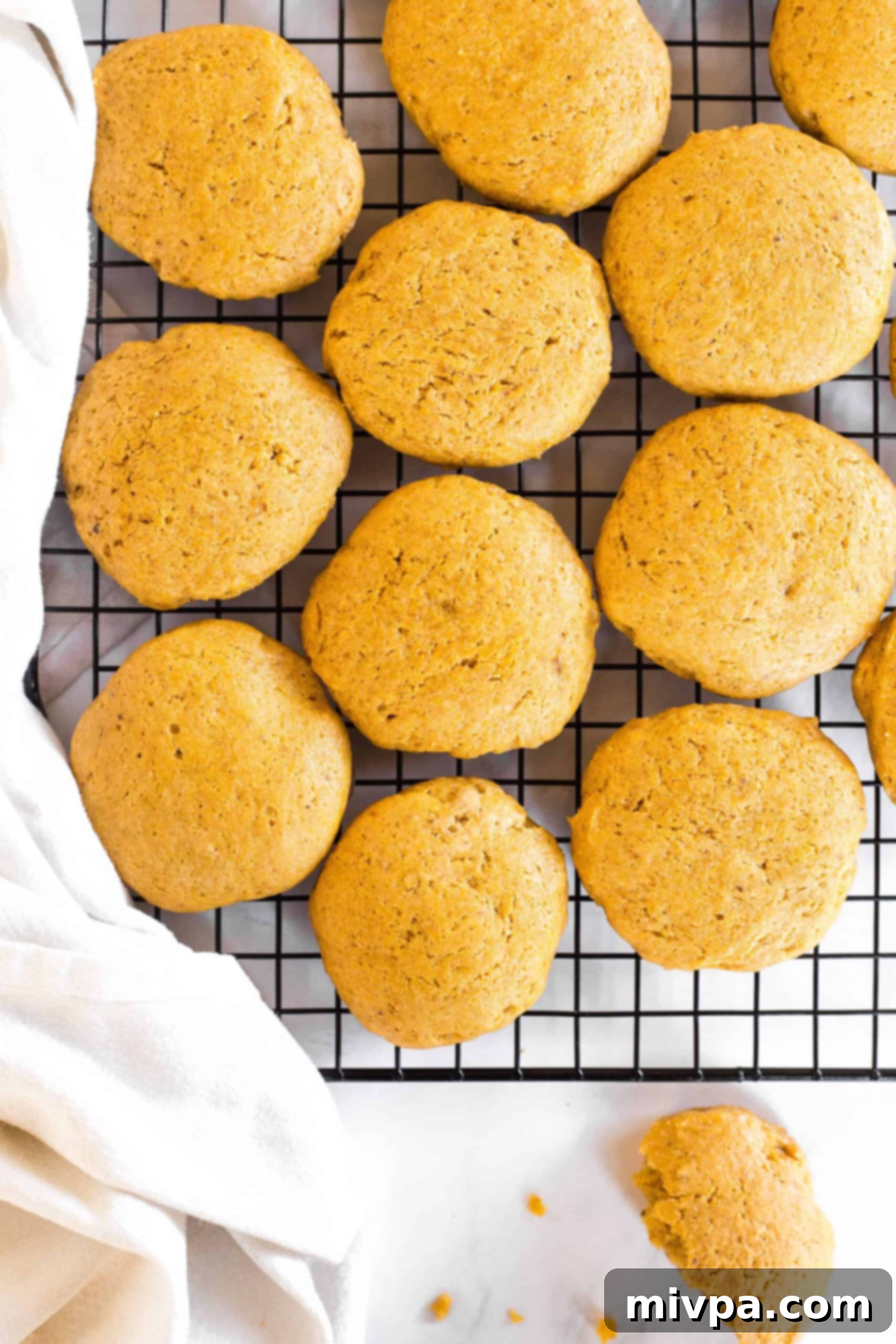 Soft pumpkin cookies cooling on a wire rack.