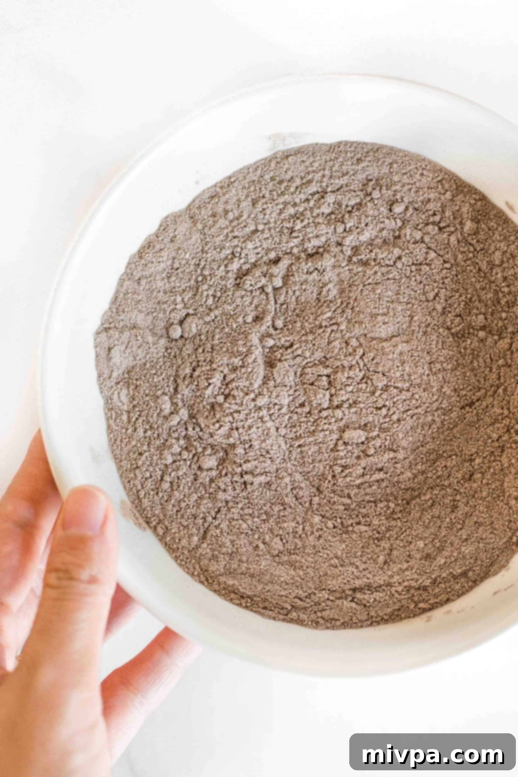 Soft, Fluffy Teff Bread (Gluten-Free, Dairy-Free) Holding a bowl of teff flour.
