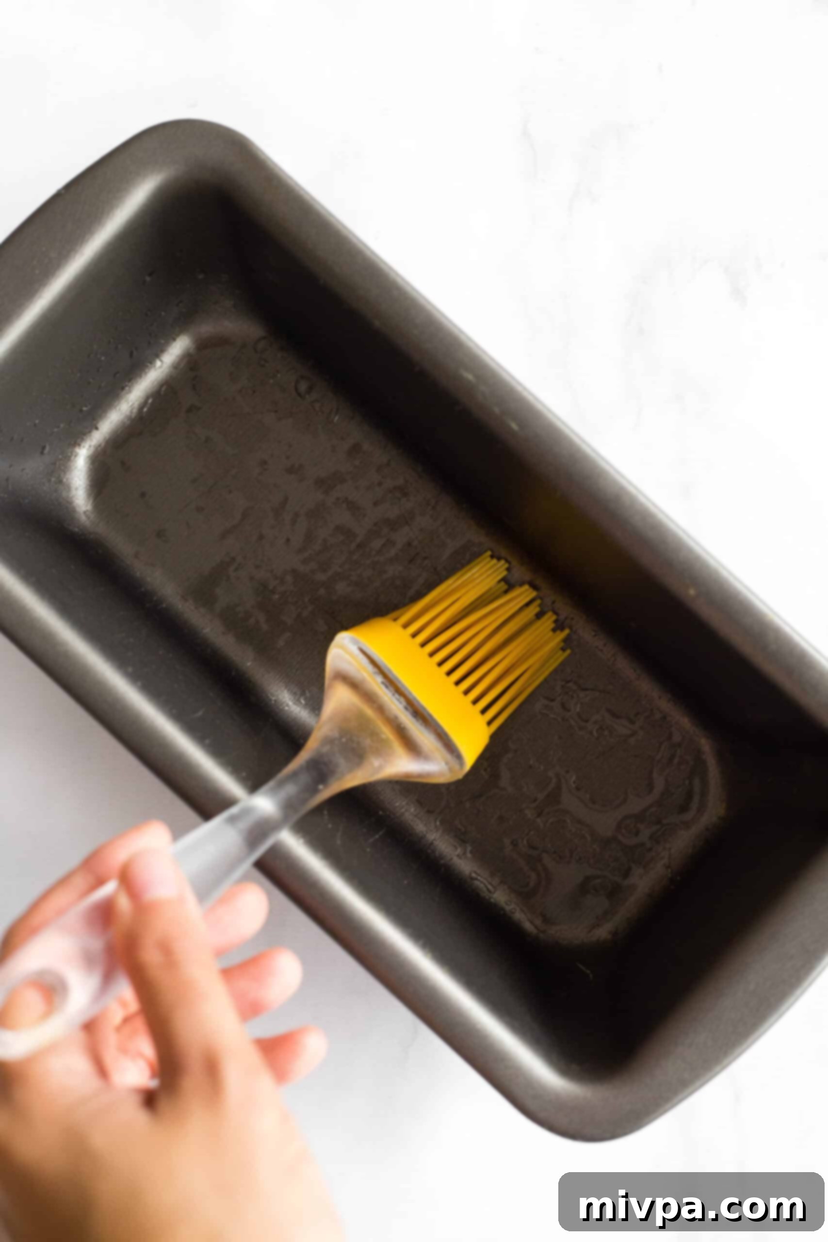 Soft, Fluffy Teff Bread (Gluten-Free, Dairy-Free) Using silicon brush to grease metal loaf pan.