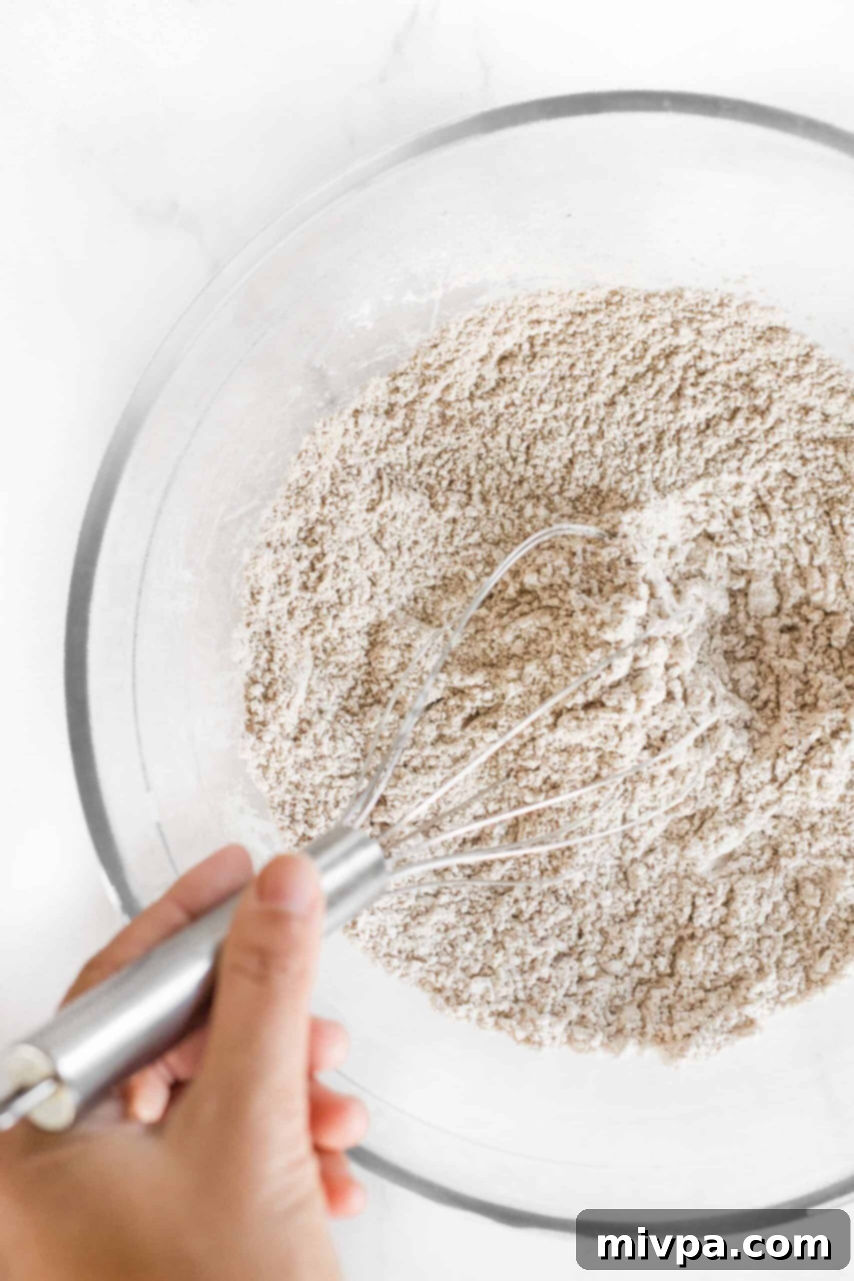Soft, Fluffy Teff Bread (Gluten-Free, Dairy-Free) Whisking flour mixture in glass bowl.