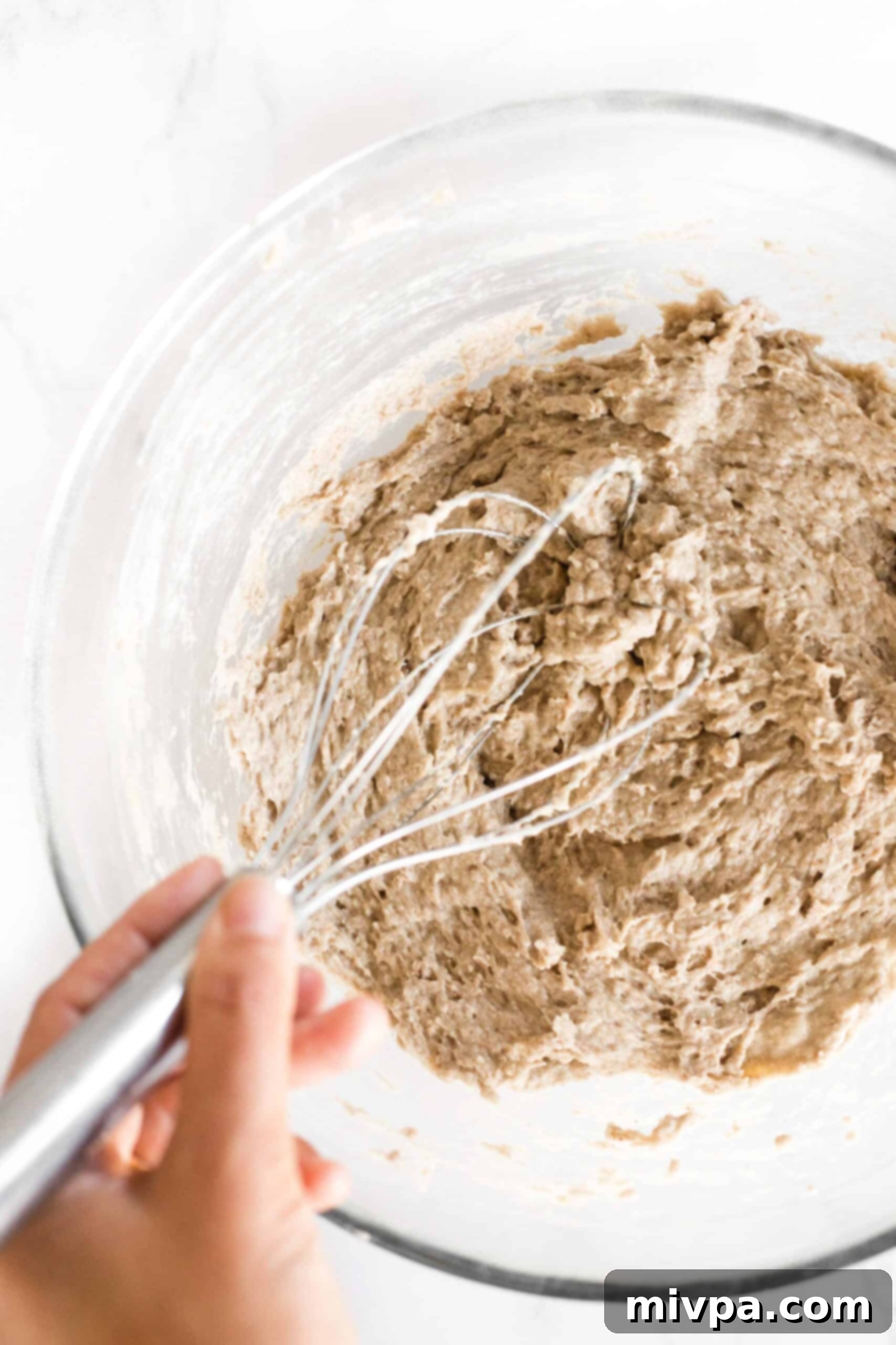 Soft, Fluffy Teff Bread (Gluten-Free, Dairy-Free) Mixing teff bread dough in glass mixing bowl.