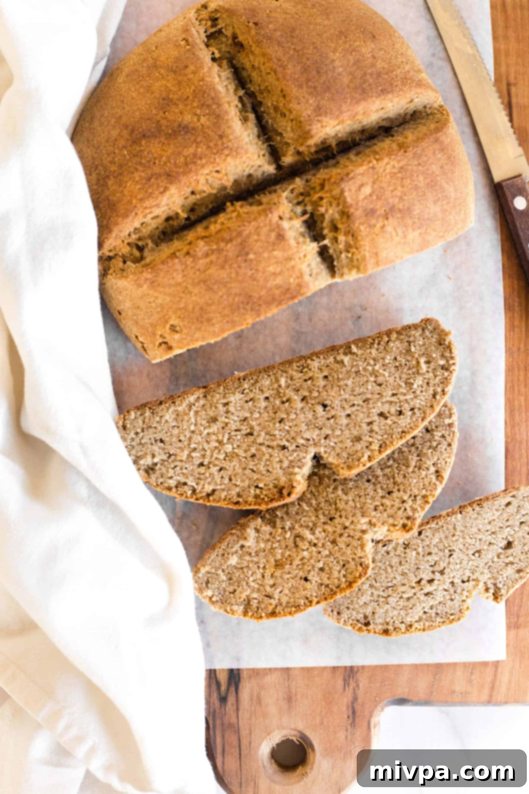 Sliced gluten-free brown bread on parchment paper