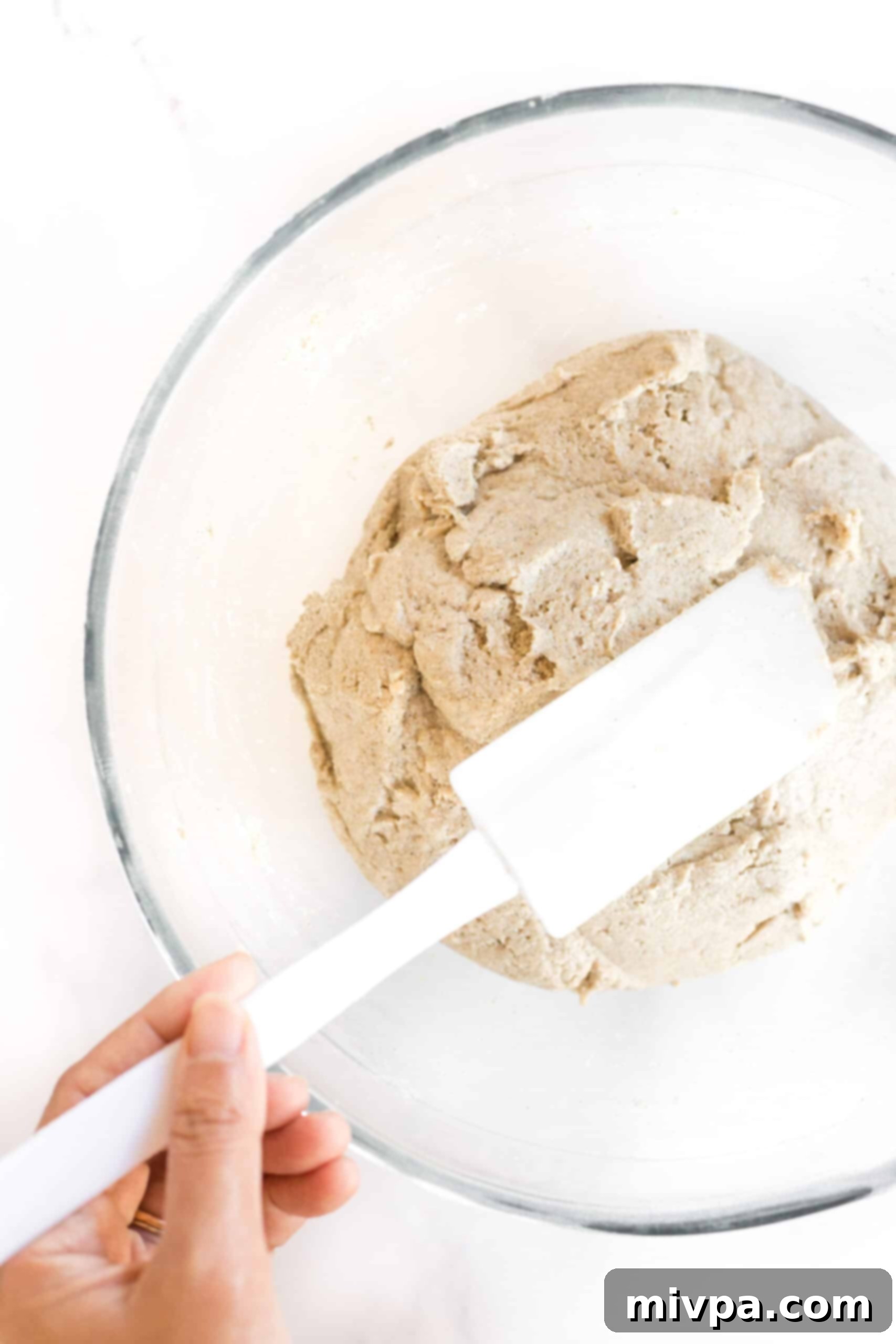 Shaping brown bread dough with spatula