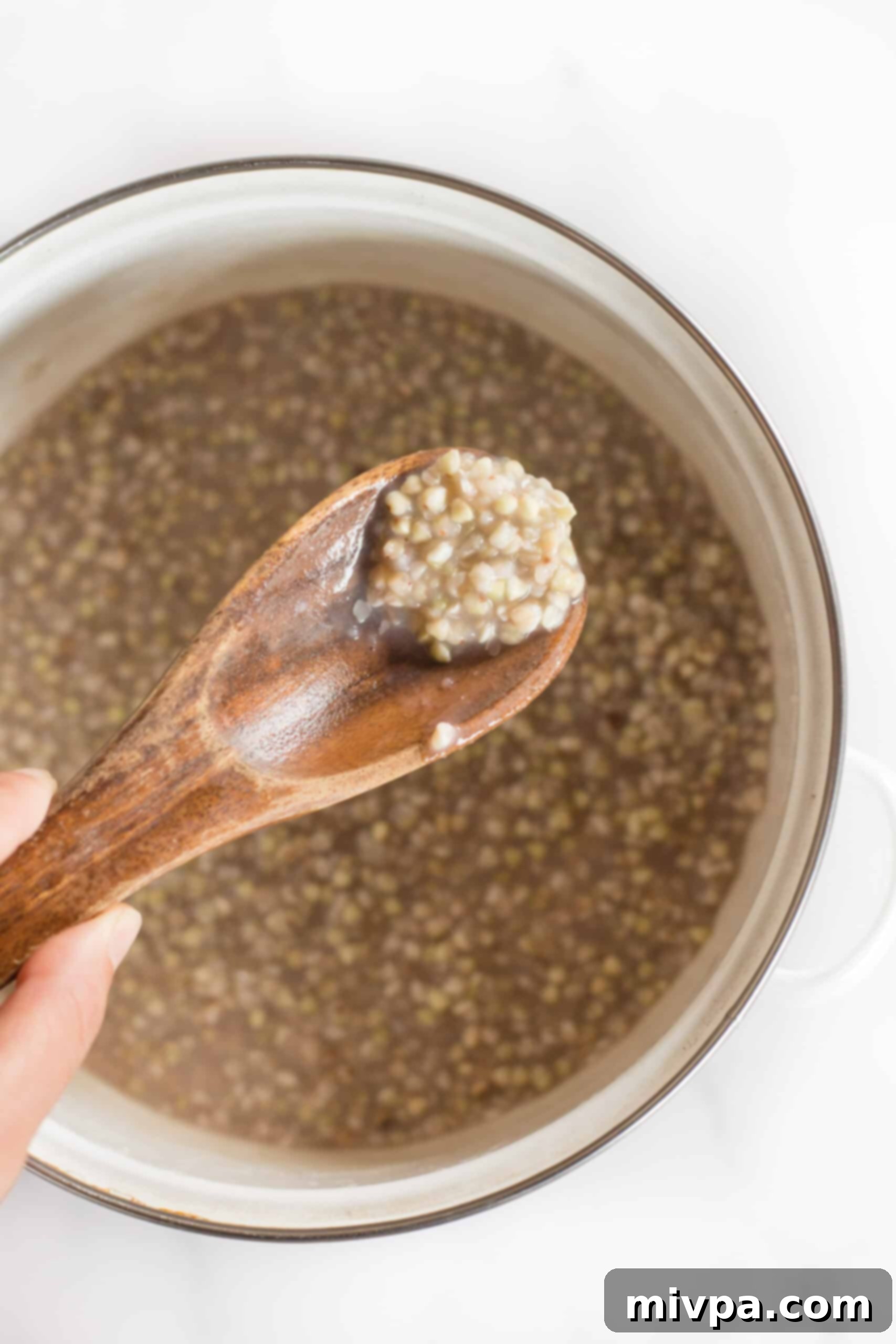 Easy Buckwheat Porridge (Gluten-Free, Vegan) Scooping up a spoonful of buckwheat porridge.