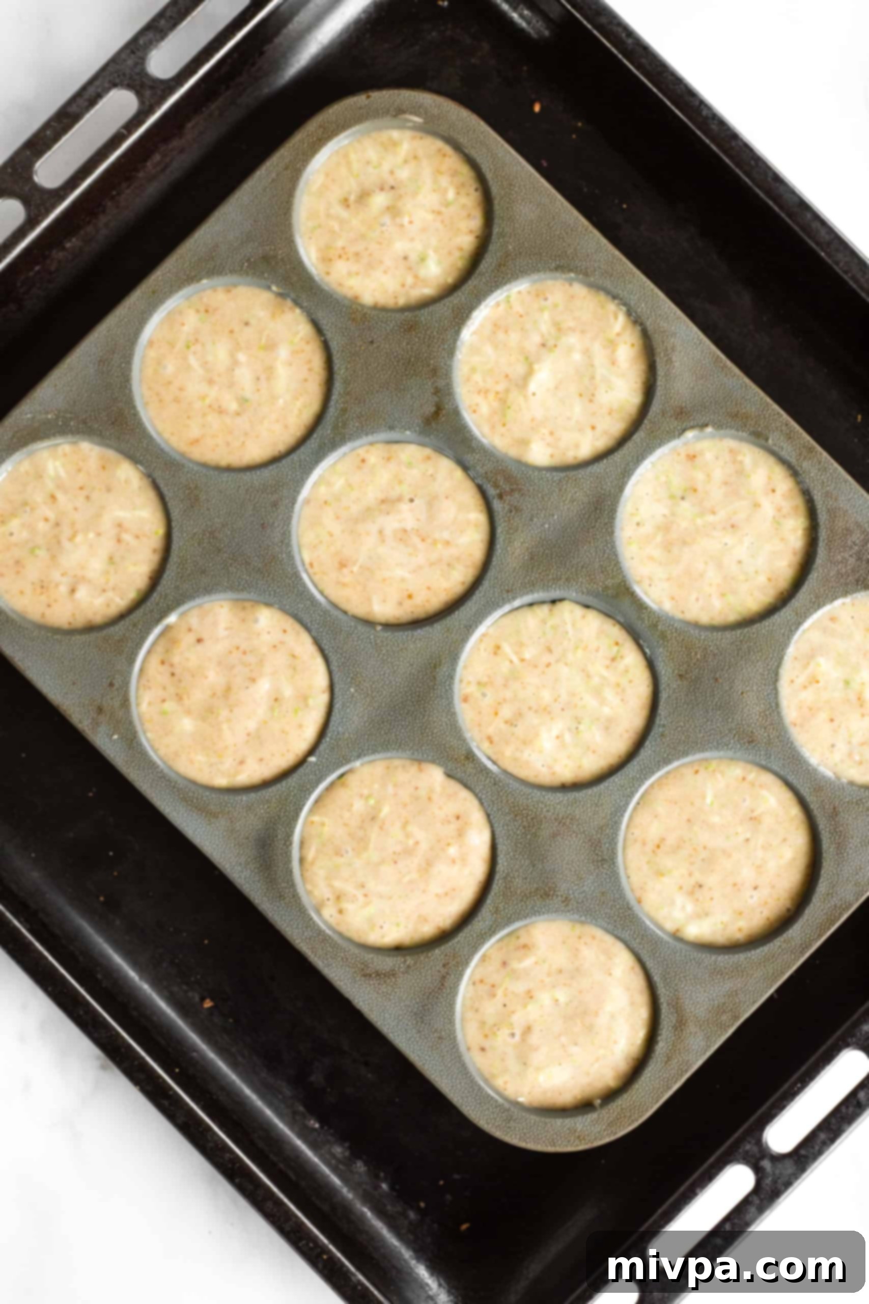 Muffin batter in silicon muffin mold.