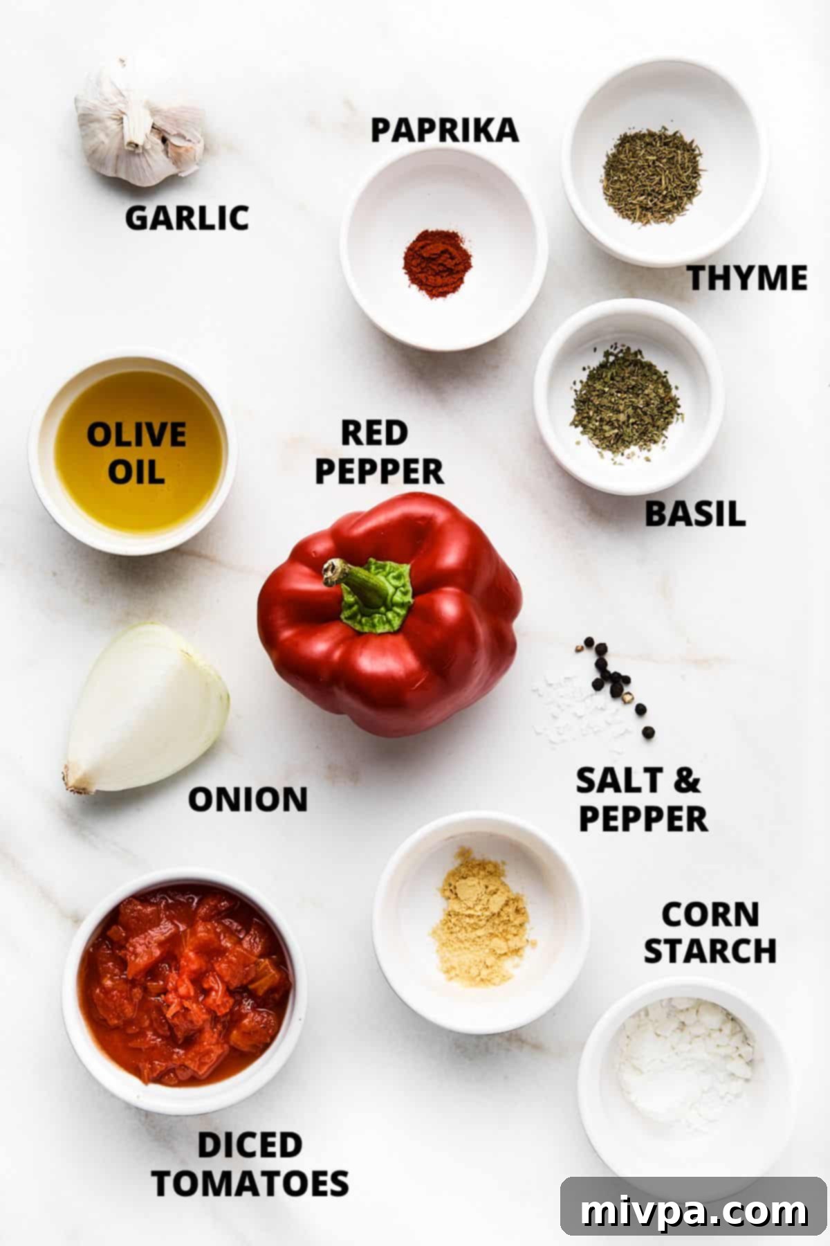 Ingredients required for making gluten-free tomato soup recipe on marble board.