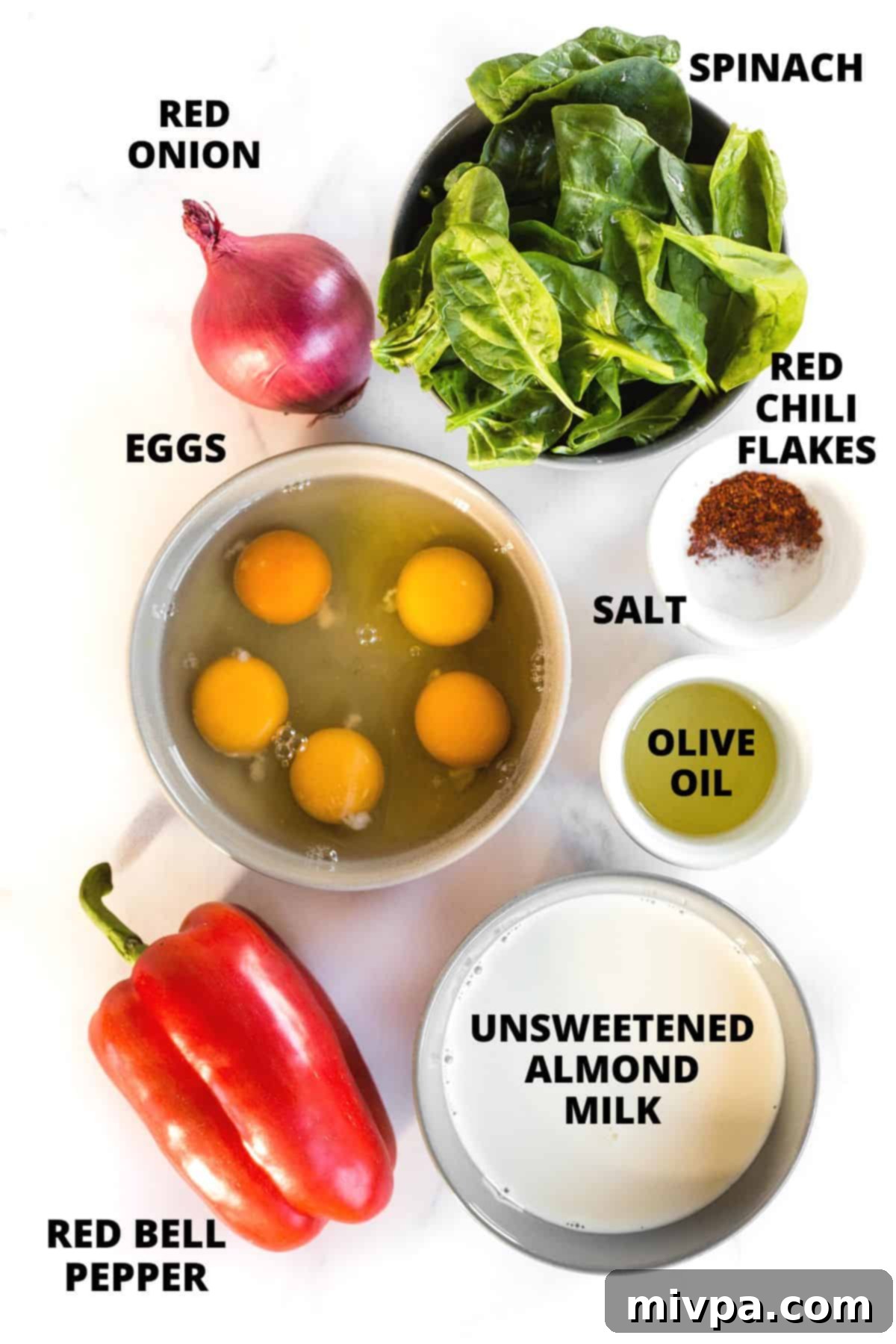 Mini Crustless Quiche Recipe (Gluten-Free, Dairy-Free) Ingredients for mini crustless quiche recipe laid out on a marble board.