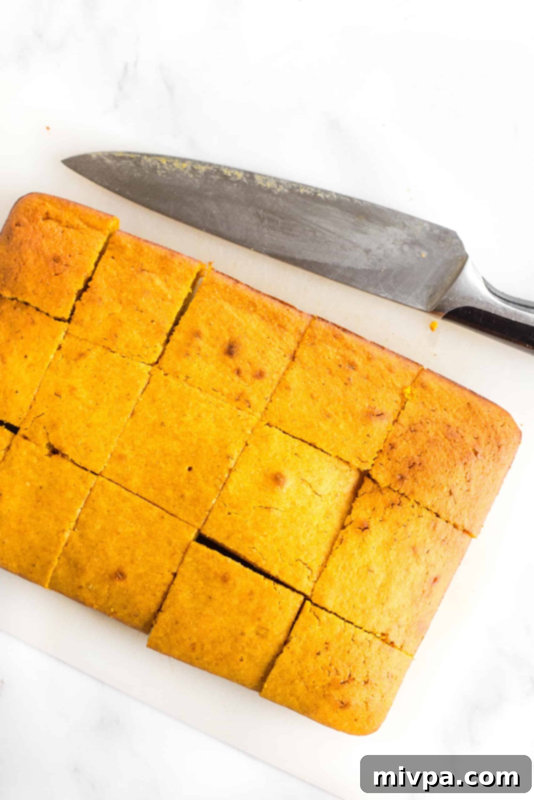 Precisely cut pumpkin squares arranged neatly on a cutting board, ready for the final touch.