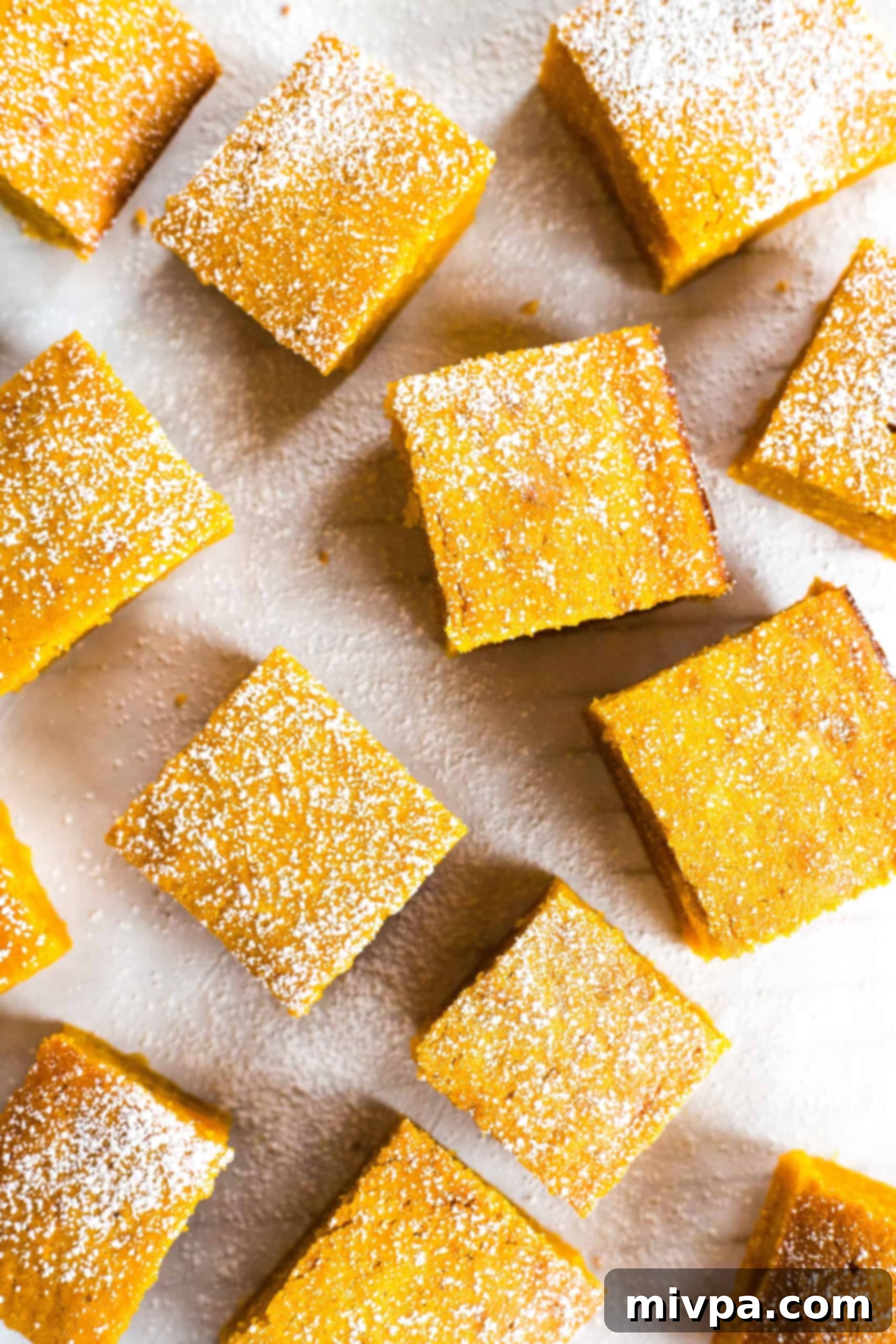 Overhead view of freshly baked pumpkin bars on a cooling rack, ready to be served.