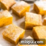 Gluten-free pumpkin bars, freshly baked and dusted with powdered sugar.