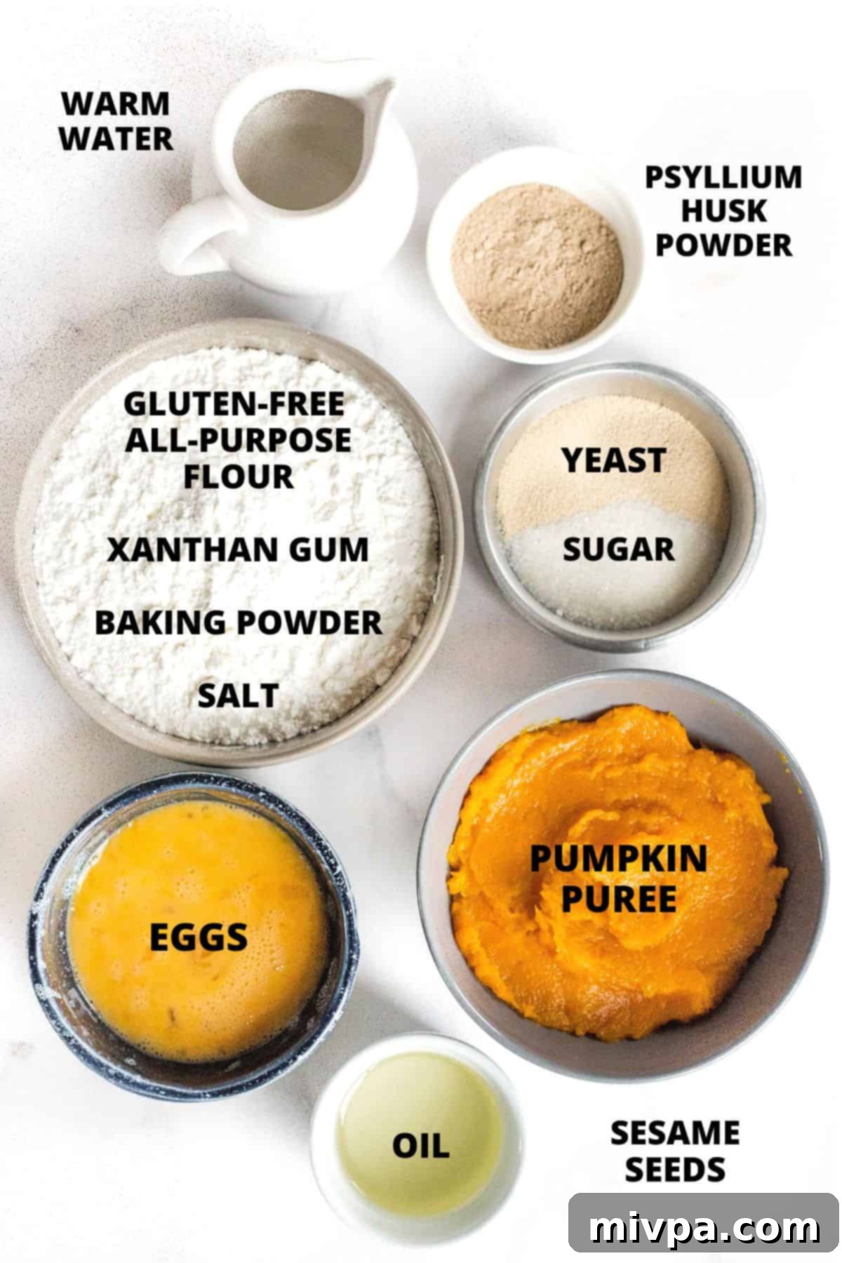 All the necessary ingredients for the gluten-free pumpkin bagel recipe neatly arranged on a marble board.