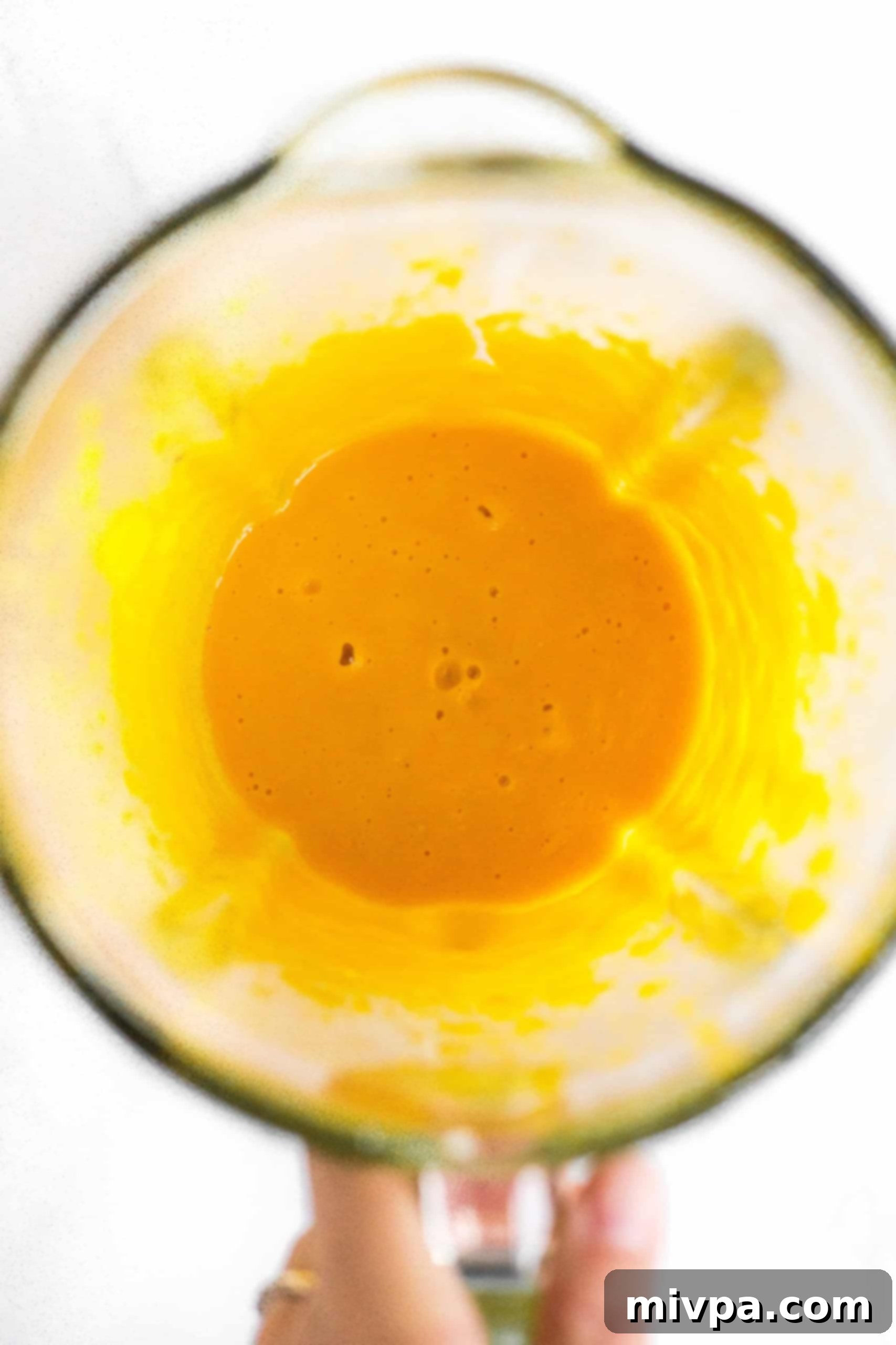 Orange liquid mixture in blender.