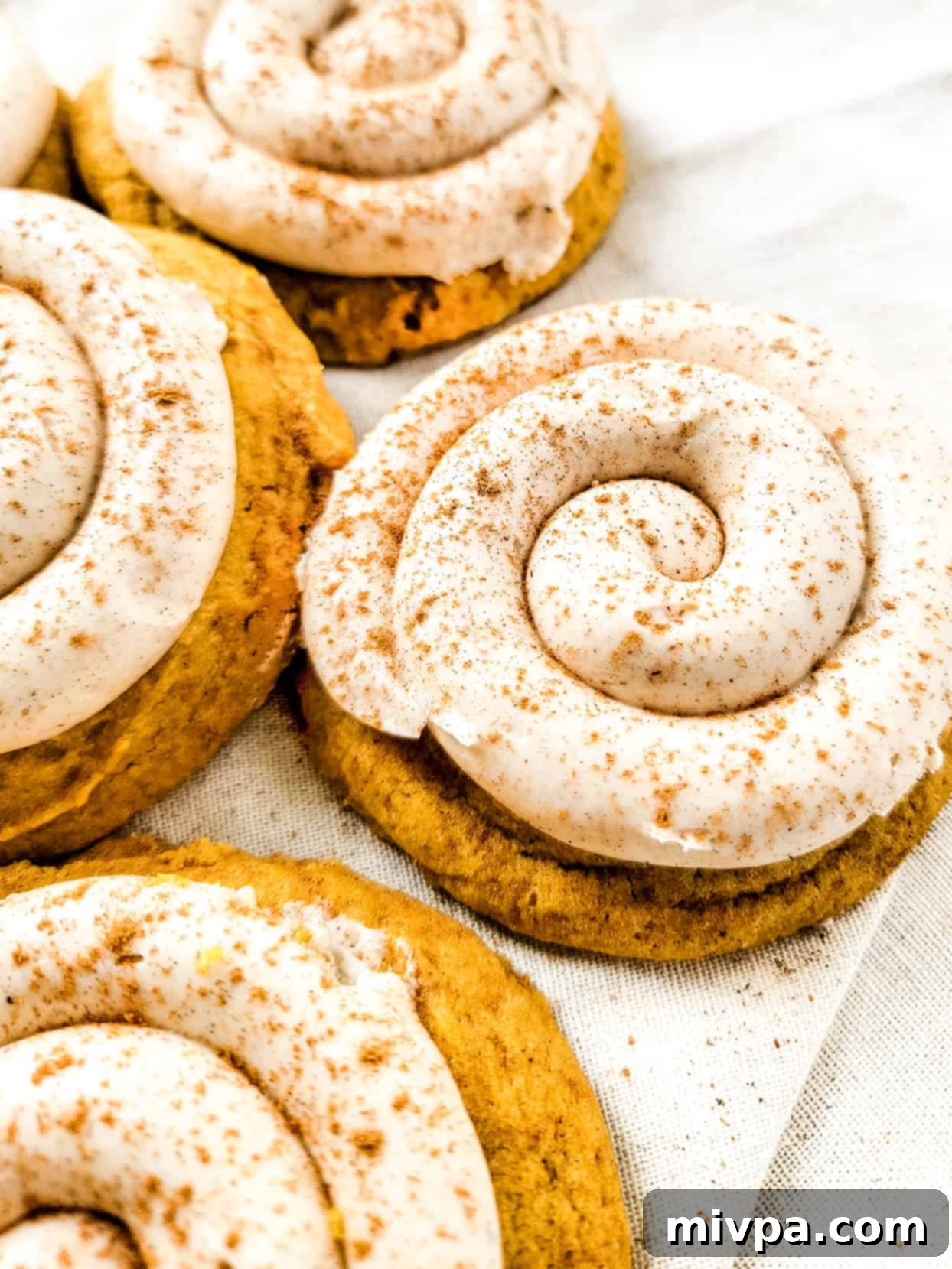 Gluten-Free Crumbl Cookies (Dairy-Free) Gluten-free pumpkin crumbl cookies on a towel.
