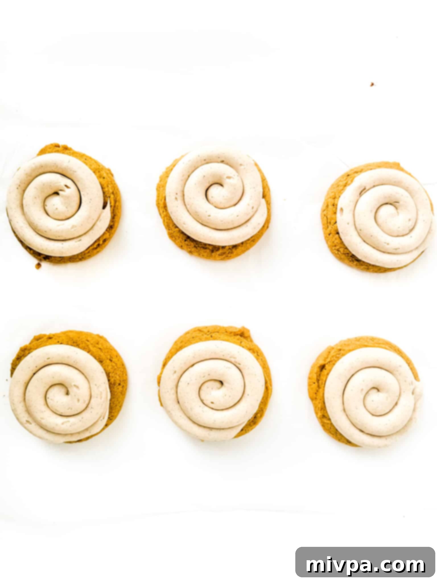 Pumpkin Crumbl Cookies (Gluten-Free, Dairy-Free) Pumpkin cookies topped with frosting.