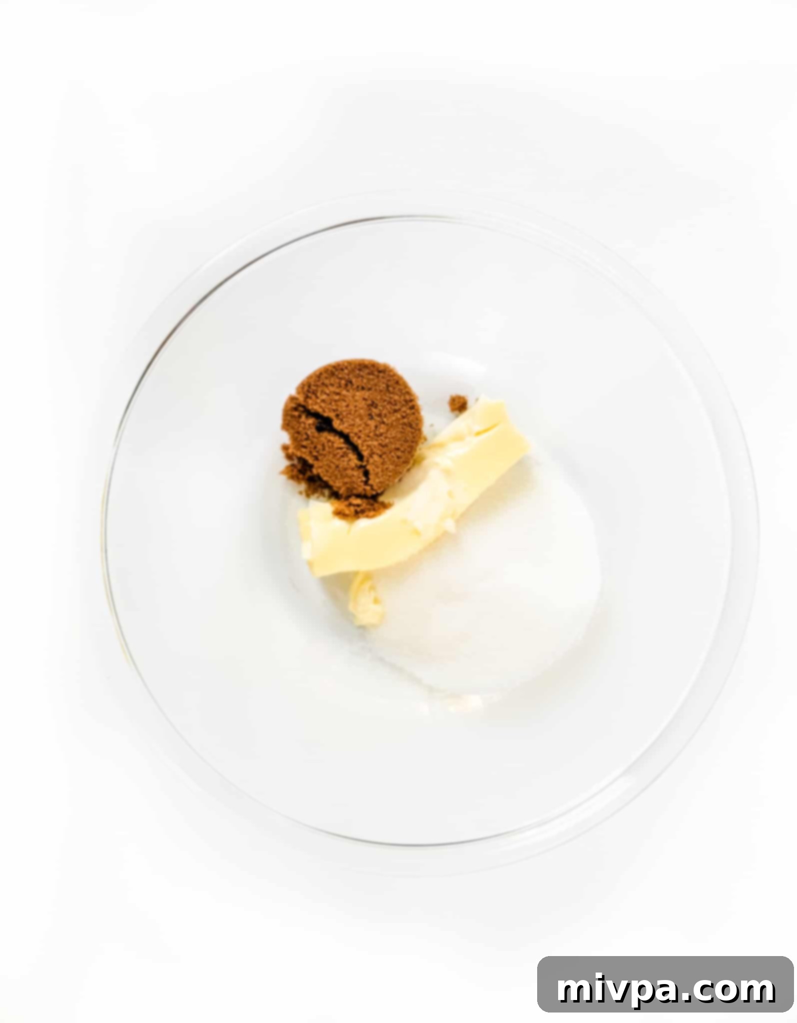 Gluten-Free Pumpkin Crumbl Cookies (Dairy-Free) A glass bowl with sugar and butter.