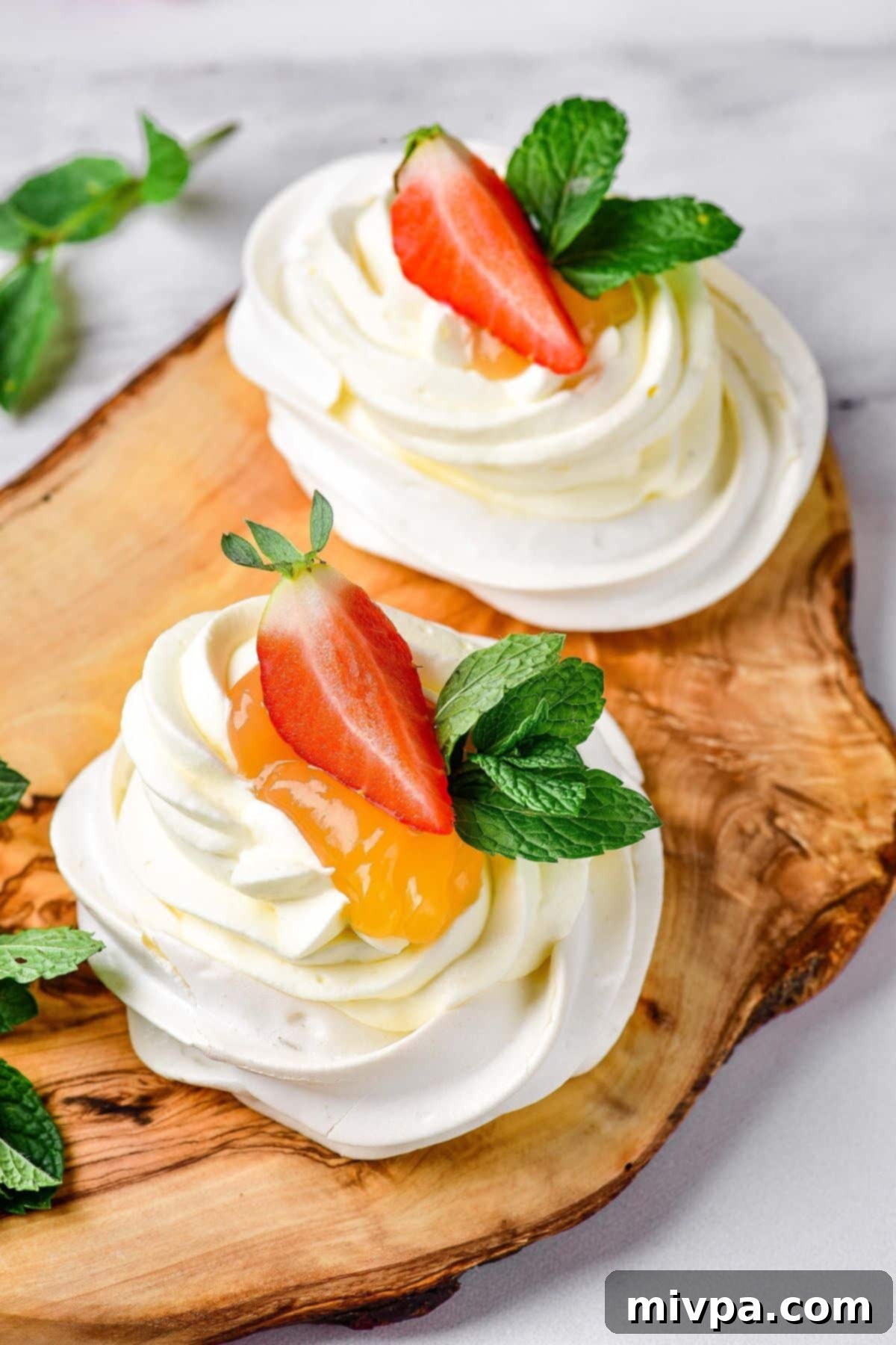 Up close shot of gluten-free pavlova on wooden board.