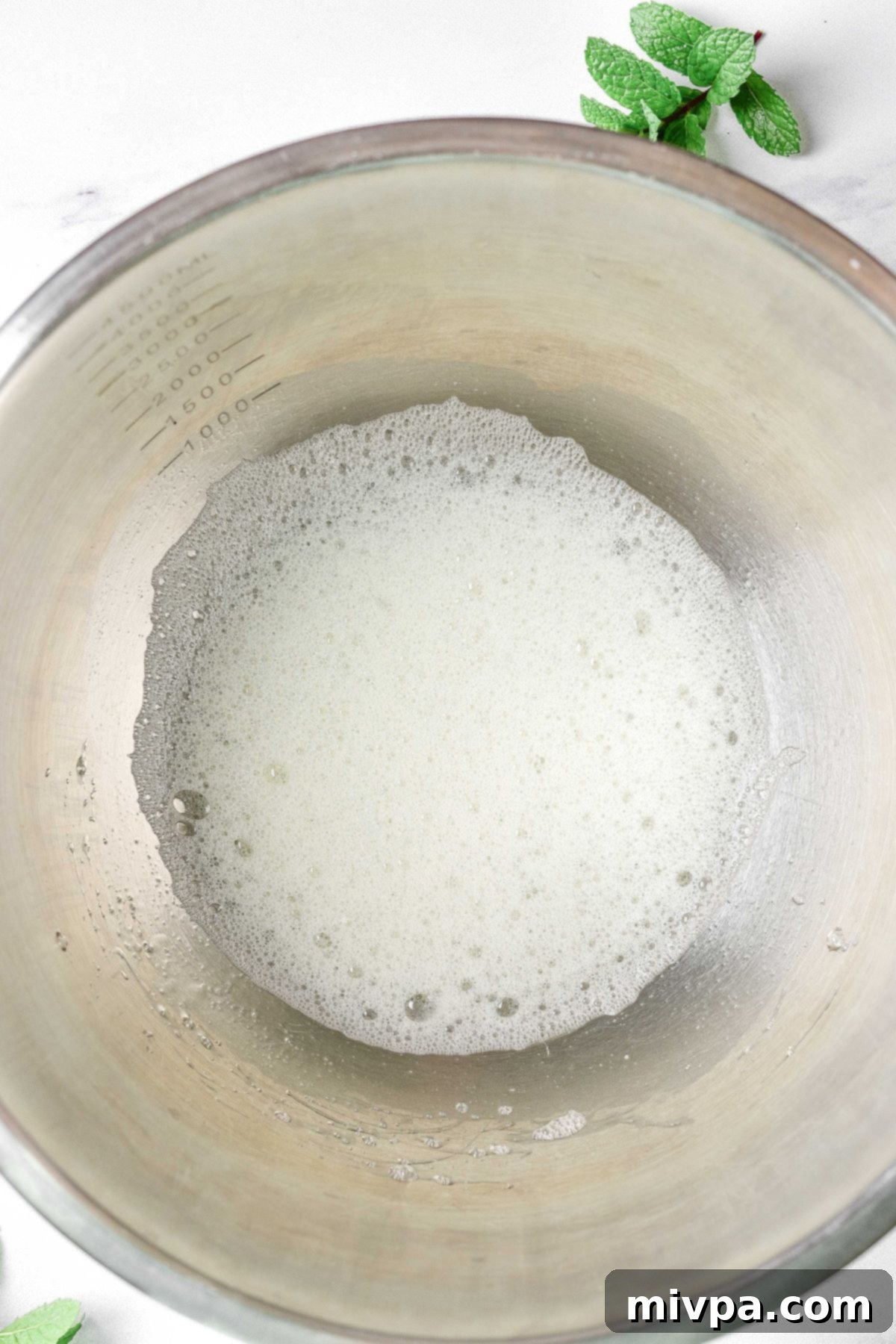Egg white mixture in metal bowl.