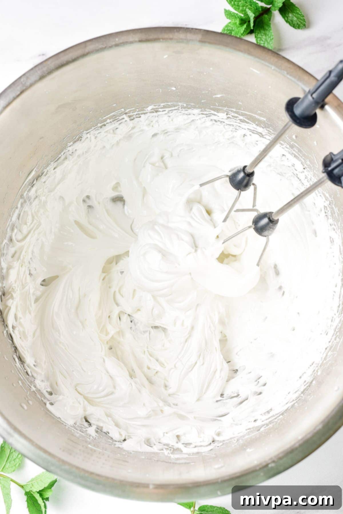 Beaten egg white mixture in metal bowl