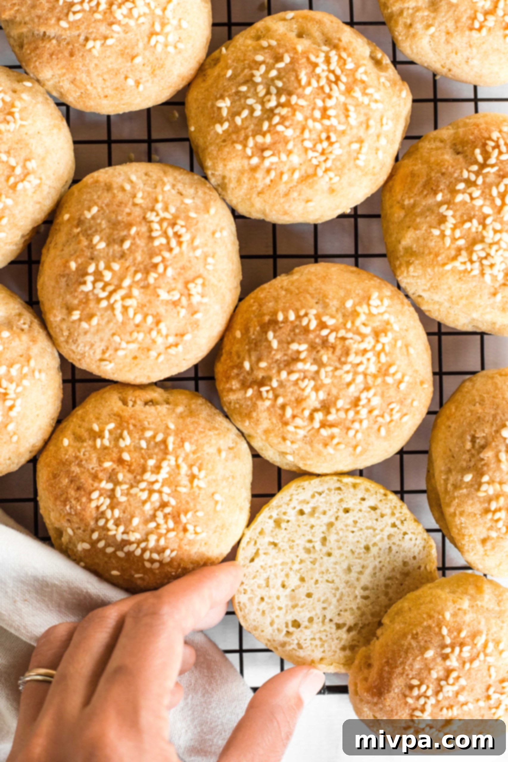 Freshly baked gluten-free slider buns cooling on a wire rack, ready to be enjoyed.
