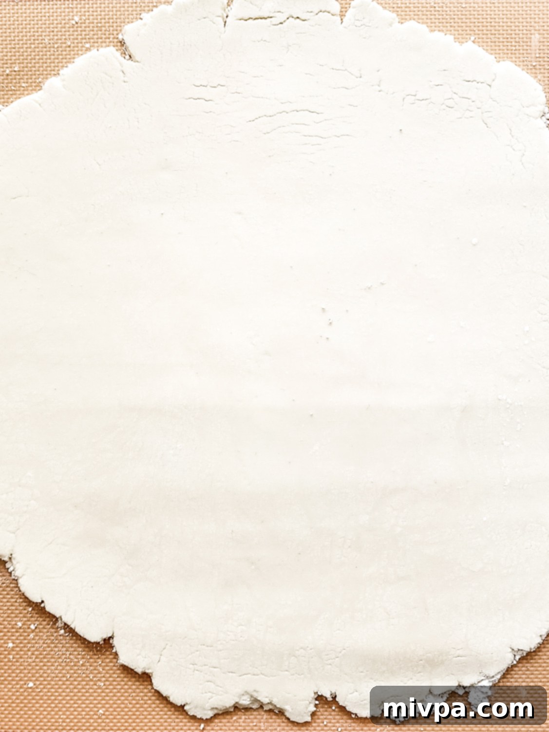 Peppermint patty dough evenly rolled out on a silpat mat.