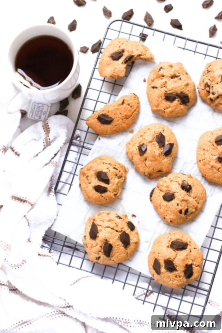 Almond Chocolate Chip Cookies (Gluten-Free, Dairy-Free) Top down view of almond butter chocolate chunk cookies cooling on wire rack.
