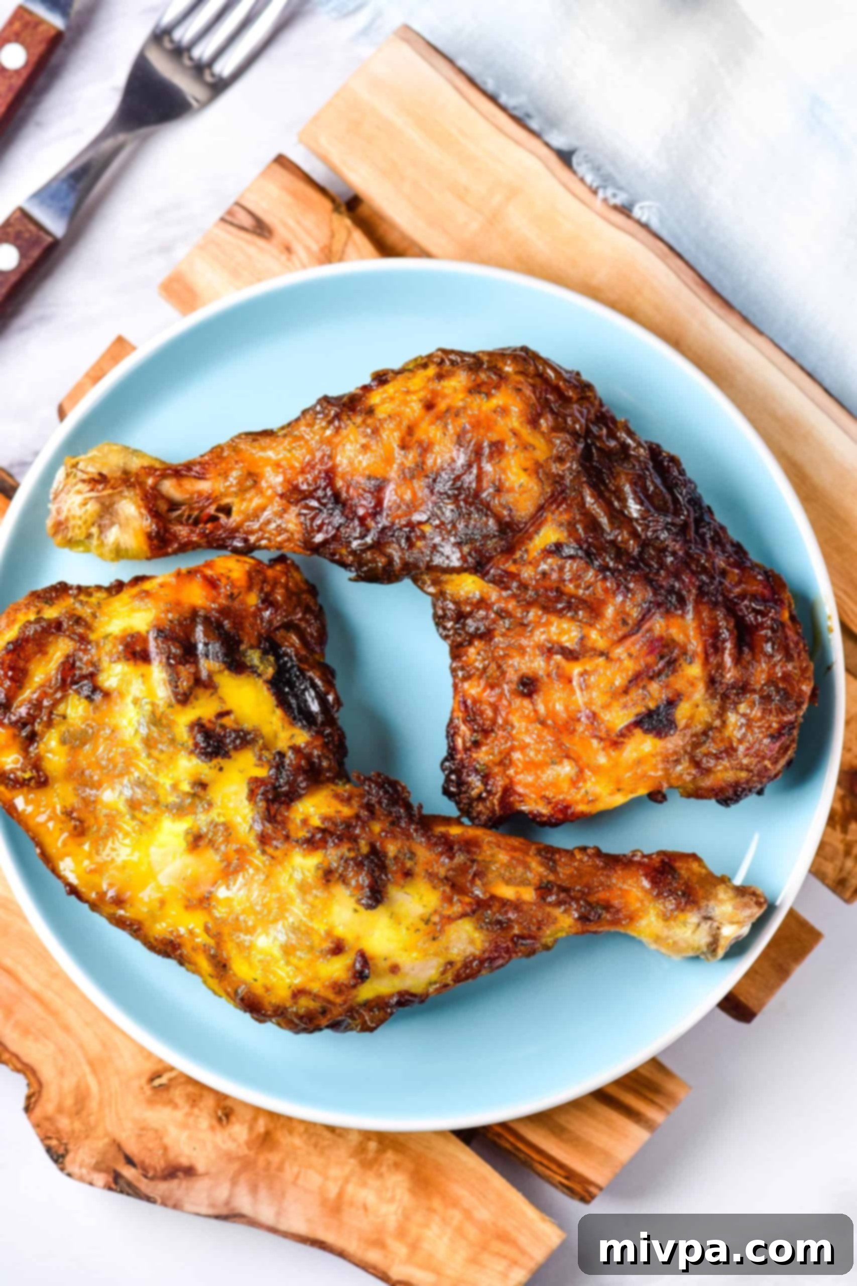 Air Fried Chicken Leg Quarters (Gluten-Free, Dairy-Free) A blue plate with two air fried chicken quarters.