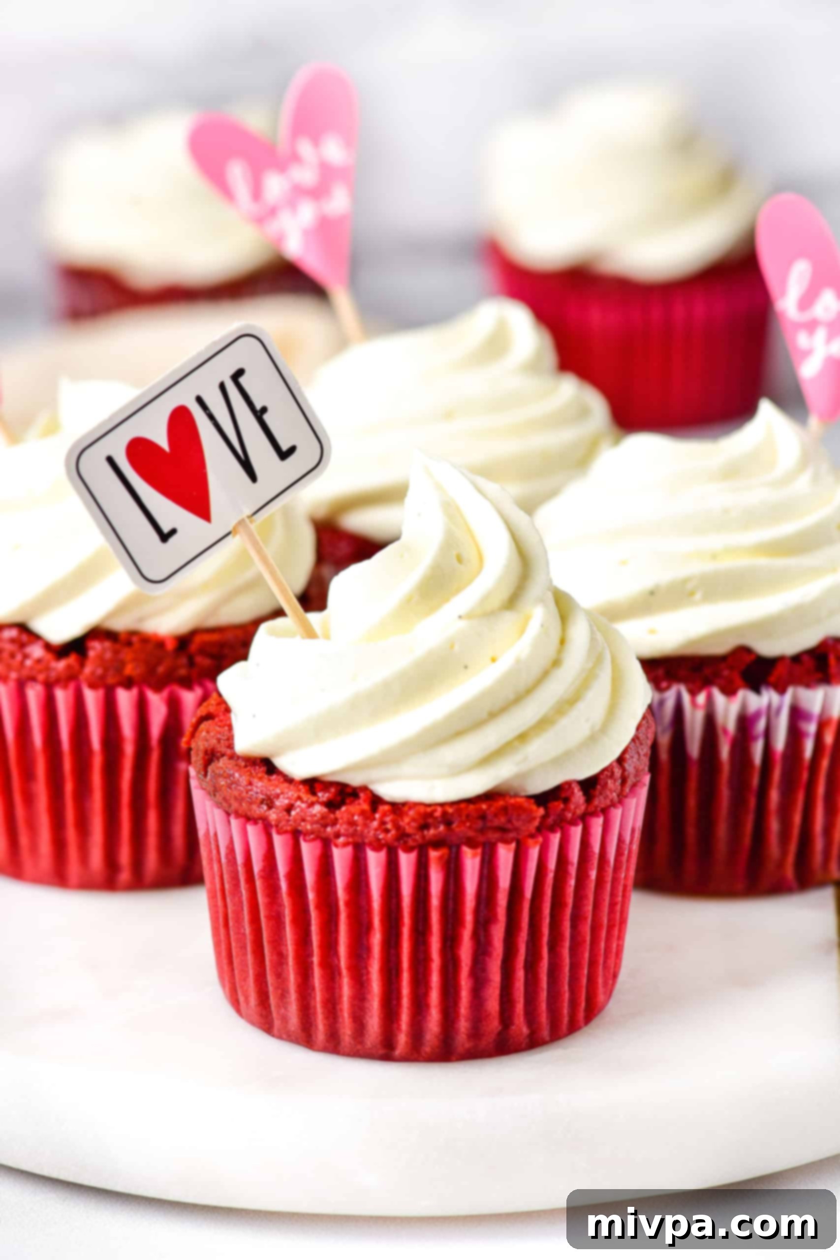 Gluten free red velvet cupcakes on cake stand.