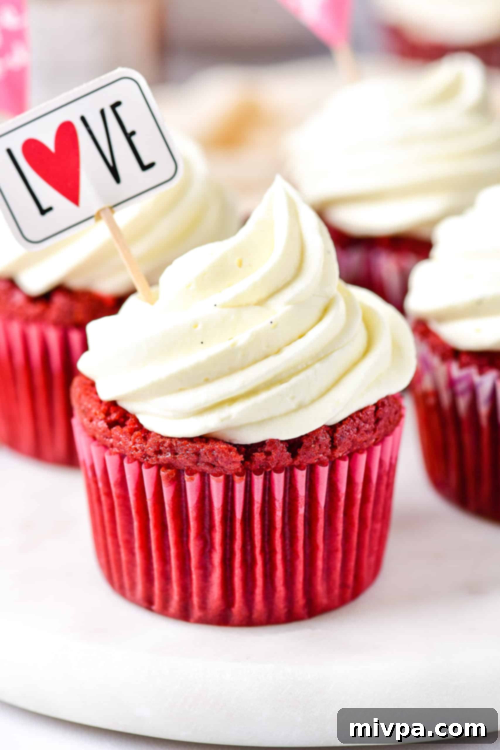Up close shot of red velvet cupcakes on cake stand.