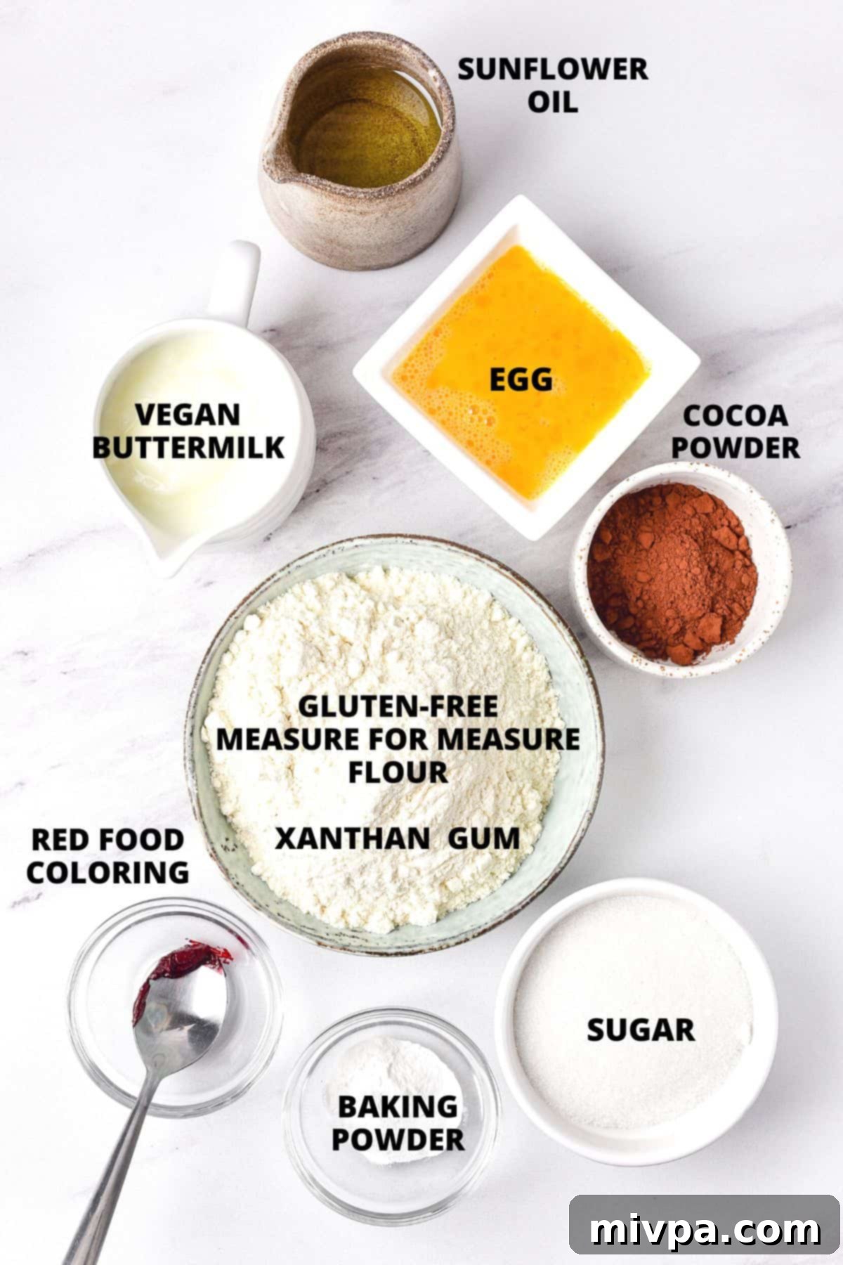Ingredients for gluten free red velvet cupcakes recipe on marble board.