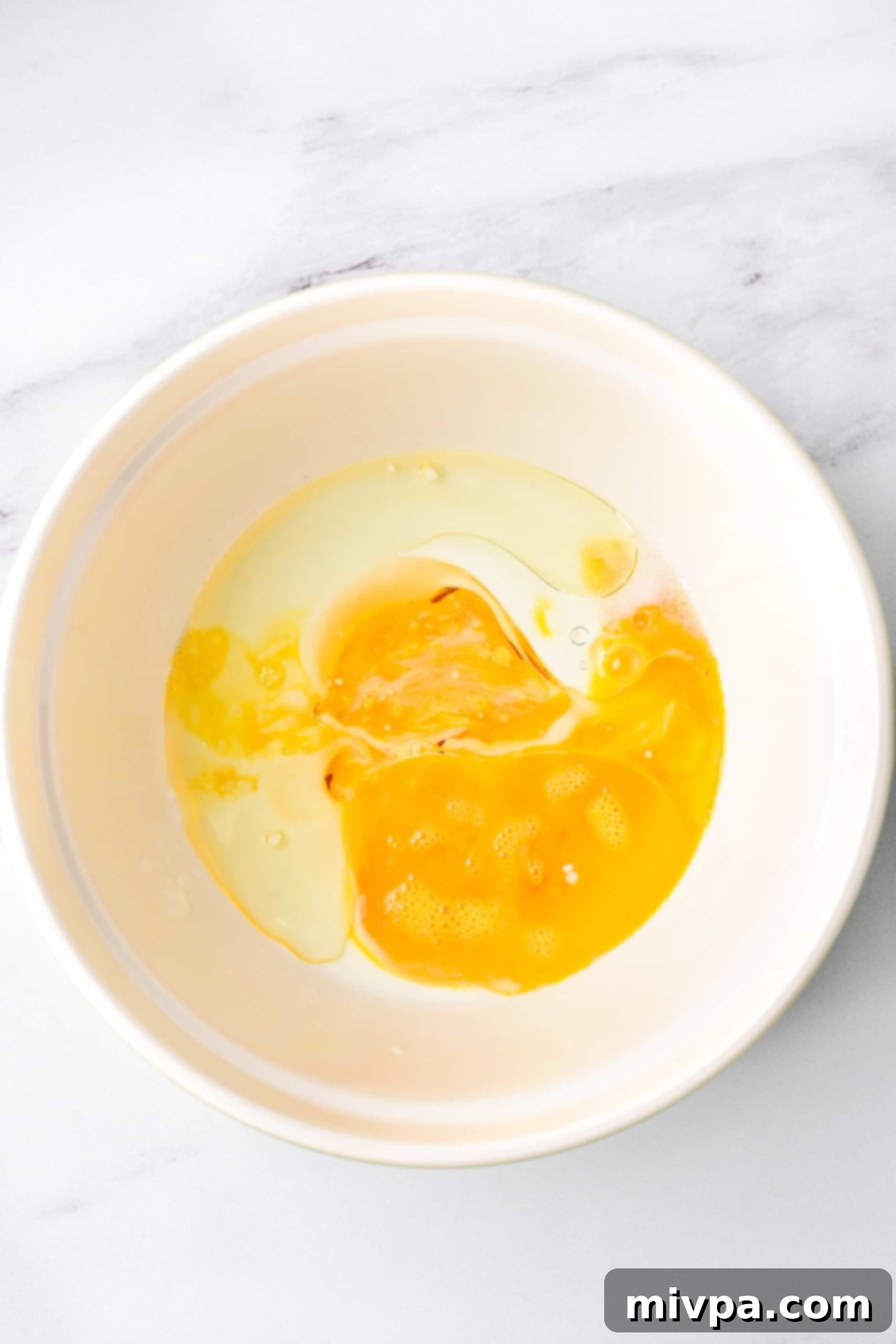 Egg mixture in white bowl.