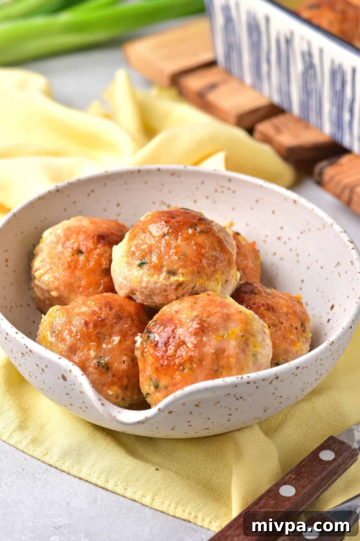 A bowl of chicken meatballs on a yellow napkin.