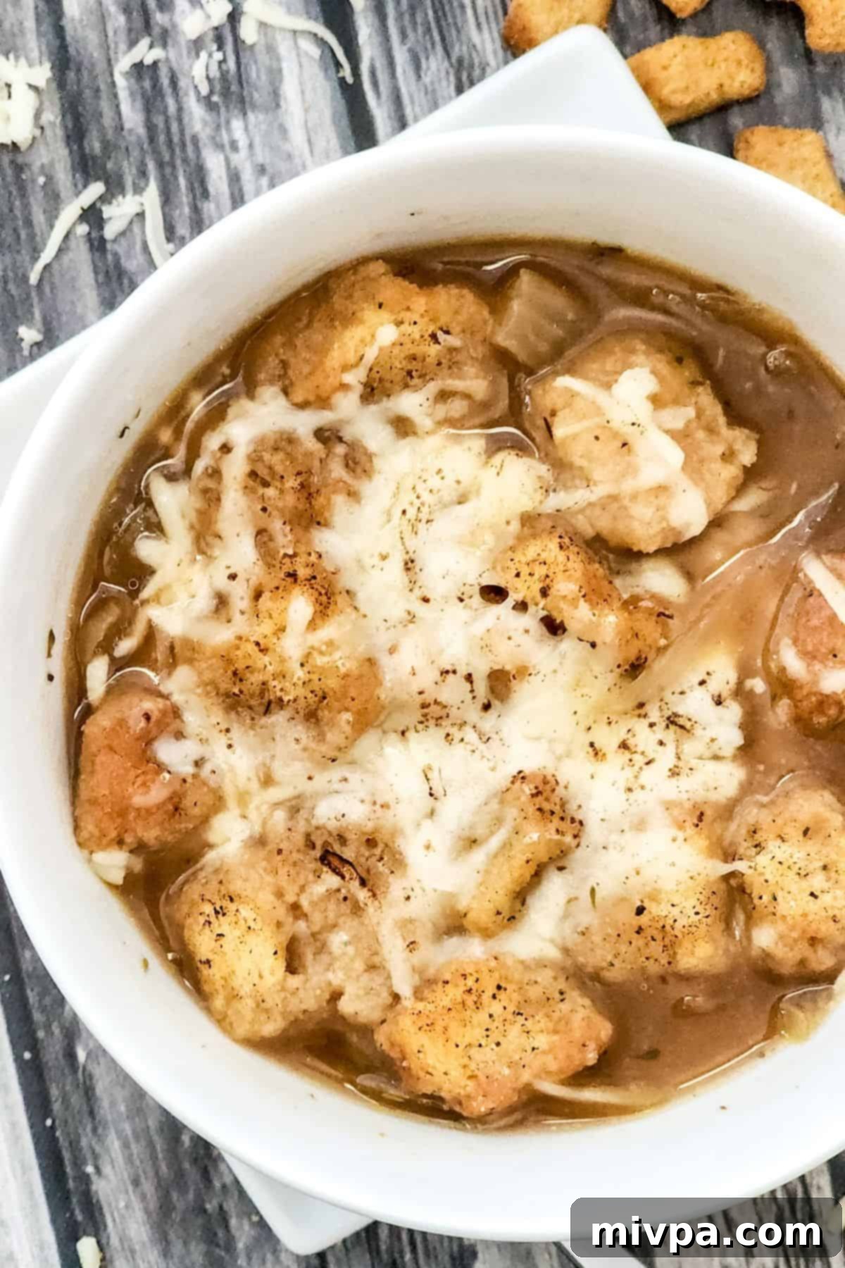 Top down view of crouton-topped onion soup.