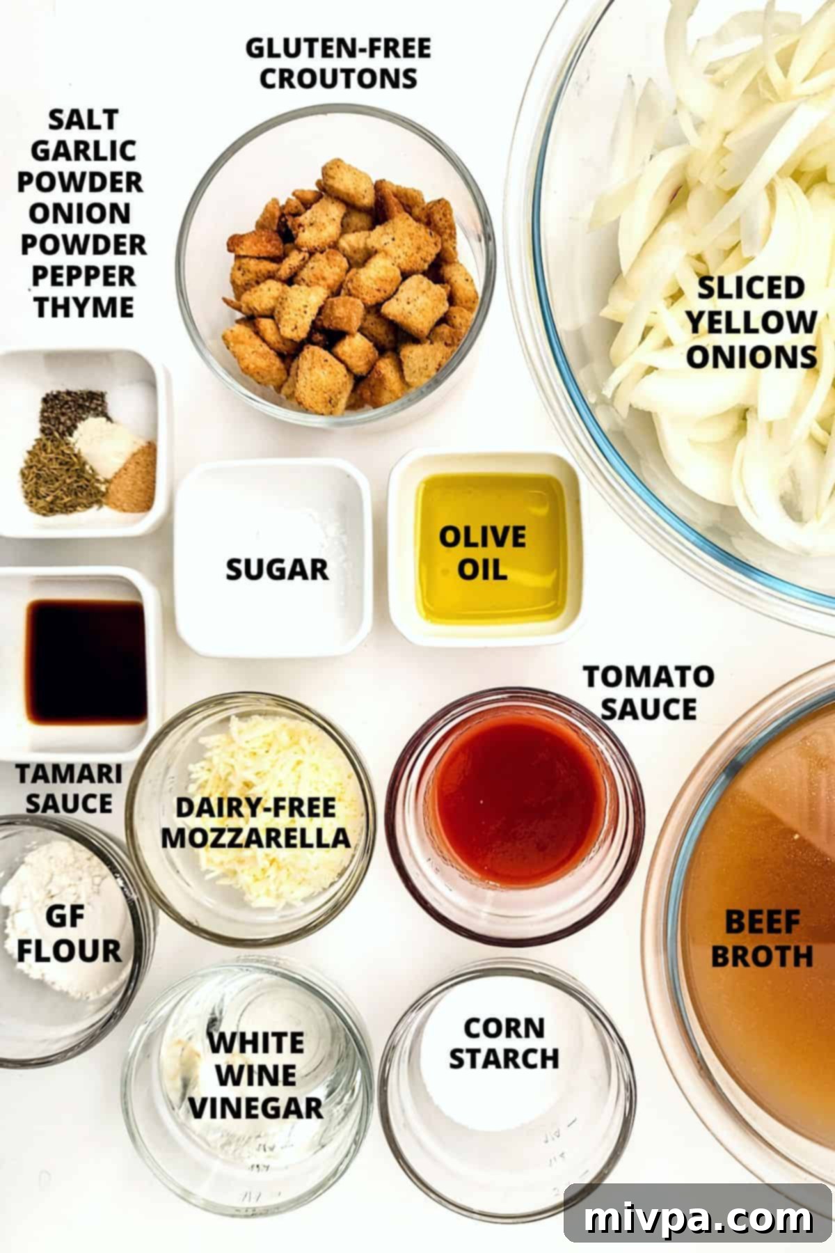 Ingredients for gluten-free French onion soup recipe laid out on marble board.