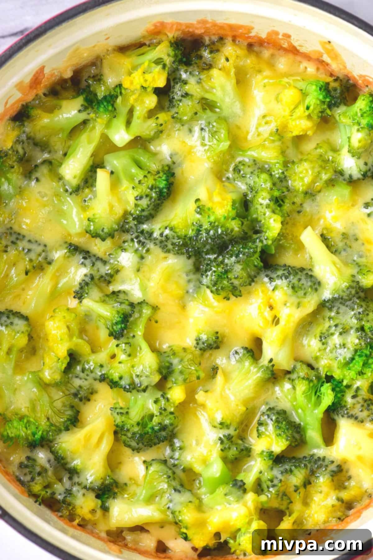 Gluten-Free Chicken Casserole (Dairy-Free) Freshly baked chicken broccoli casserole in a Dutch oven, with melted cheese and vibrant green broccoli.