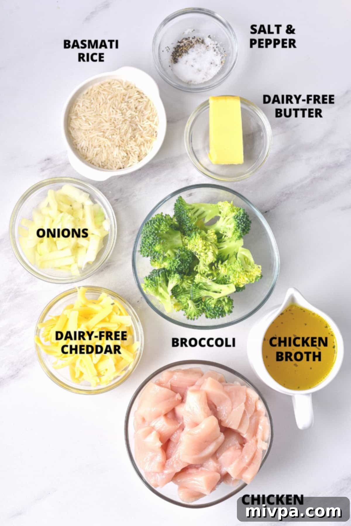 Dairy-Free Chicken Casserole (Gluten-Free) A flat lay of all the fresh ingredients required for the gluten-free chicken rice bake, including chicken, rice, broccoli, onions, and dairy-free cheese.
