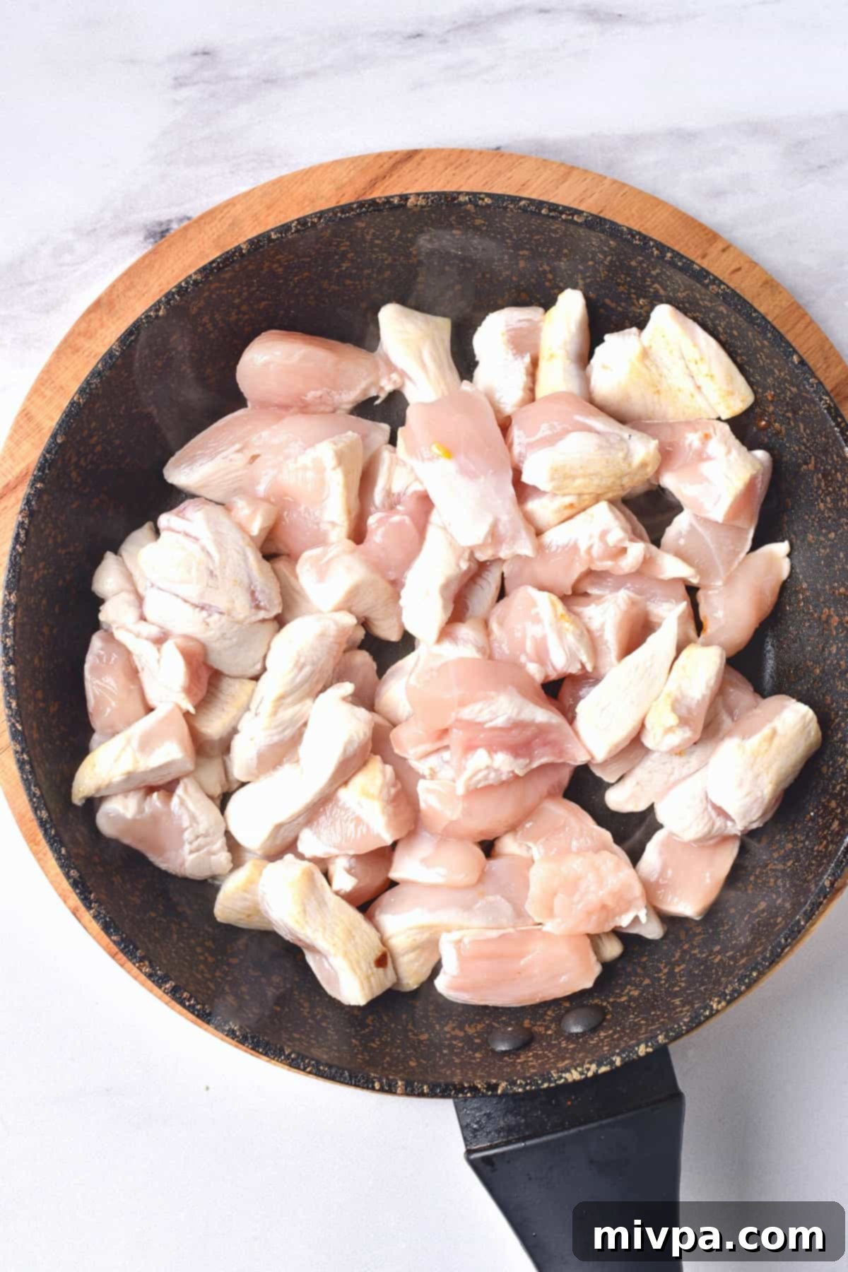 Gluten-Free Chicken Casserole Recipe (Dairy-Free) Cooking small pieces of chicken in a skillet, browning them lightly for added flavor.