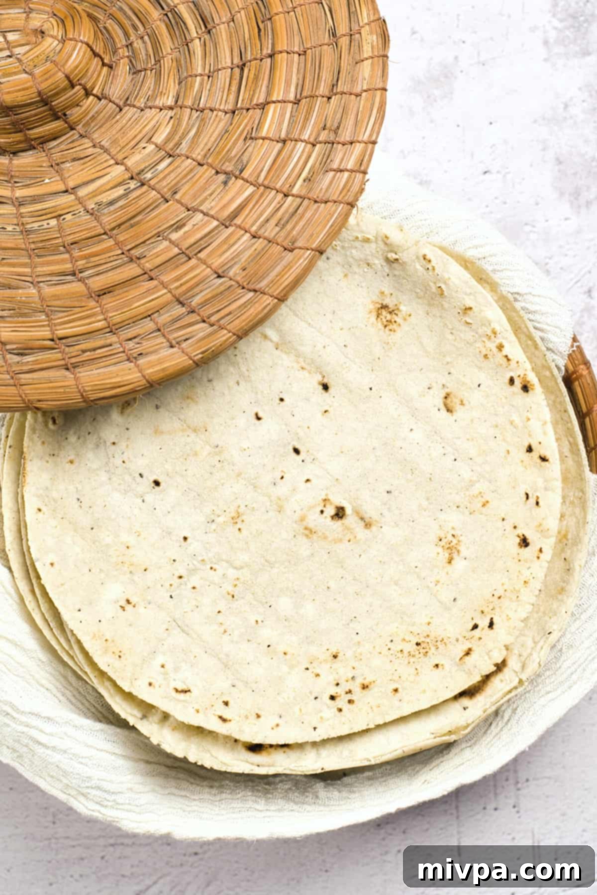 A stack of gluten-free corn tortillas in a tortilla warmer.