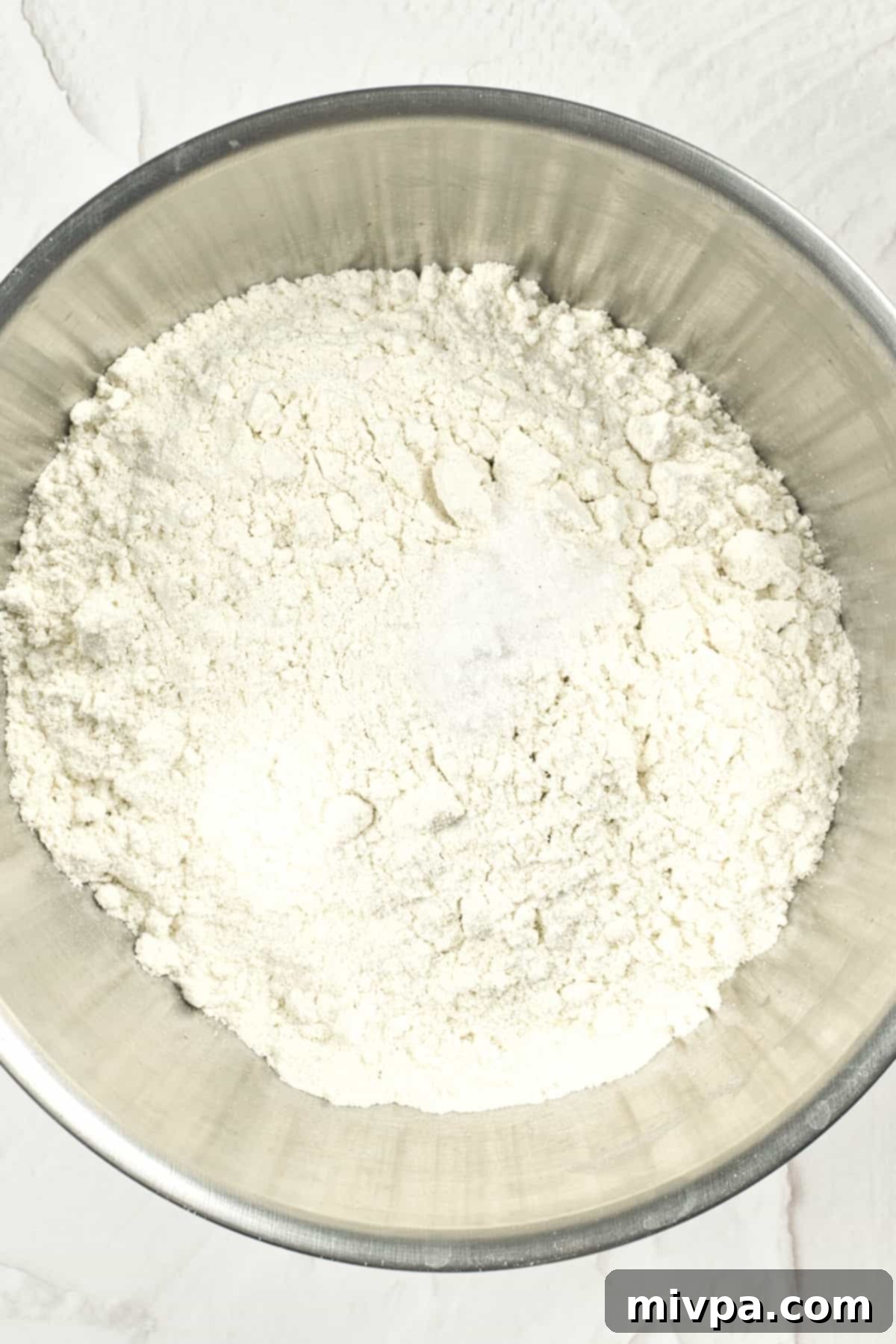 Flour mixture in a large metal bowl.