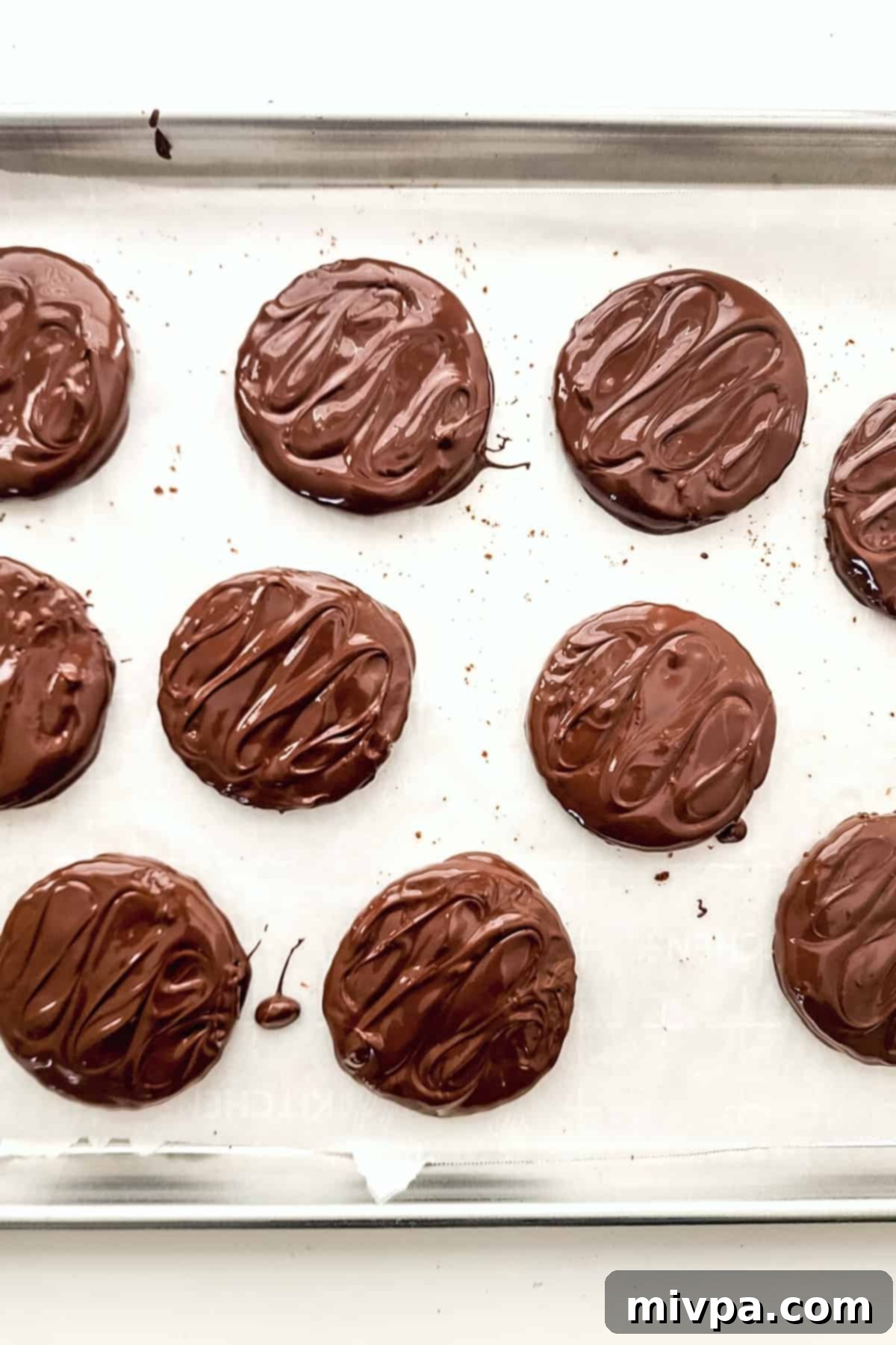 Freshly dipped chocolate mint cookies.
