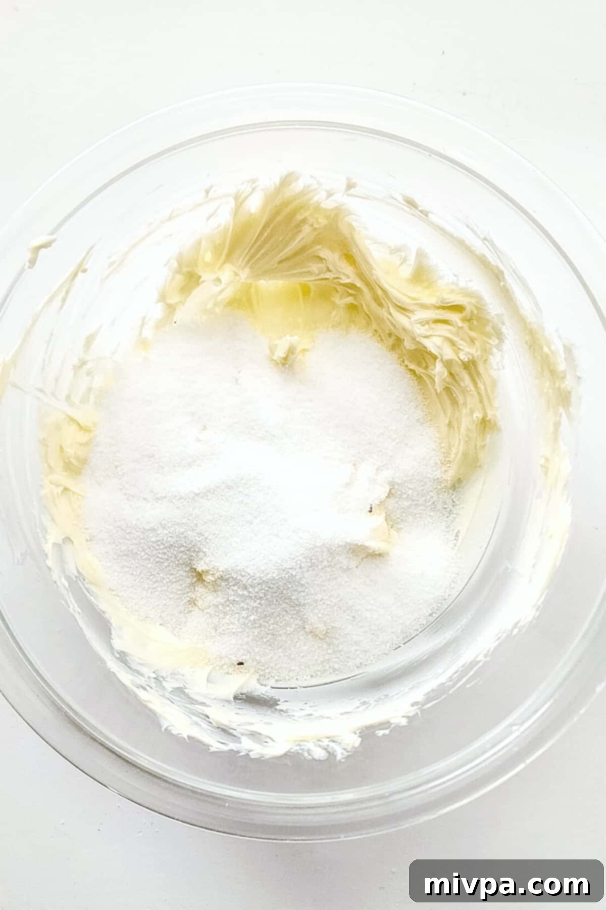 Butter and sugar mixture in glass bowl.