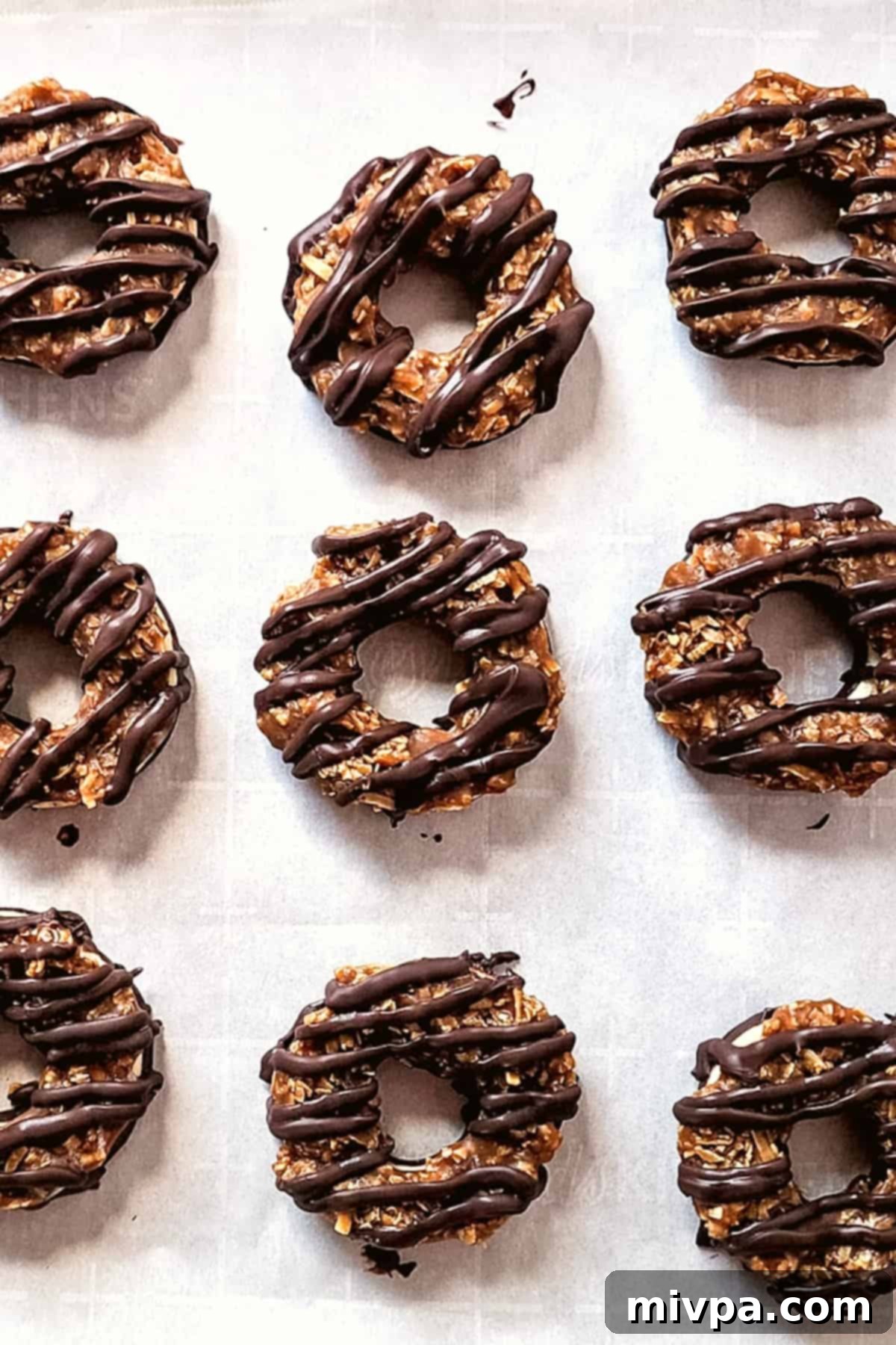 Gluten-Free Samoas Cookies (Dairy-Free) Copycat girl scout samoas on parchment paper.