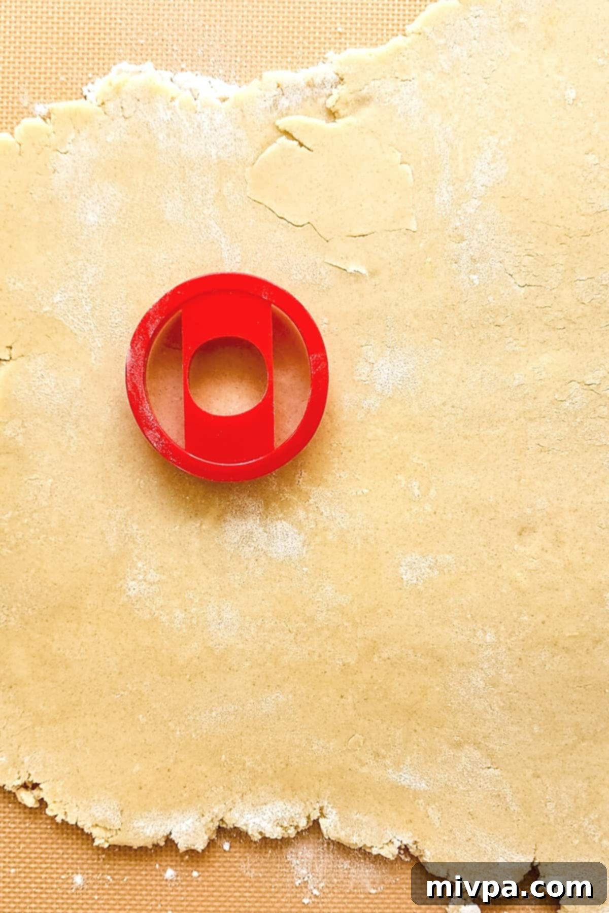Gluten-Free Samoas Cookies (Dairy-Free) Red cookie cutter on rolled out cookie dough.