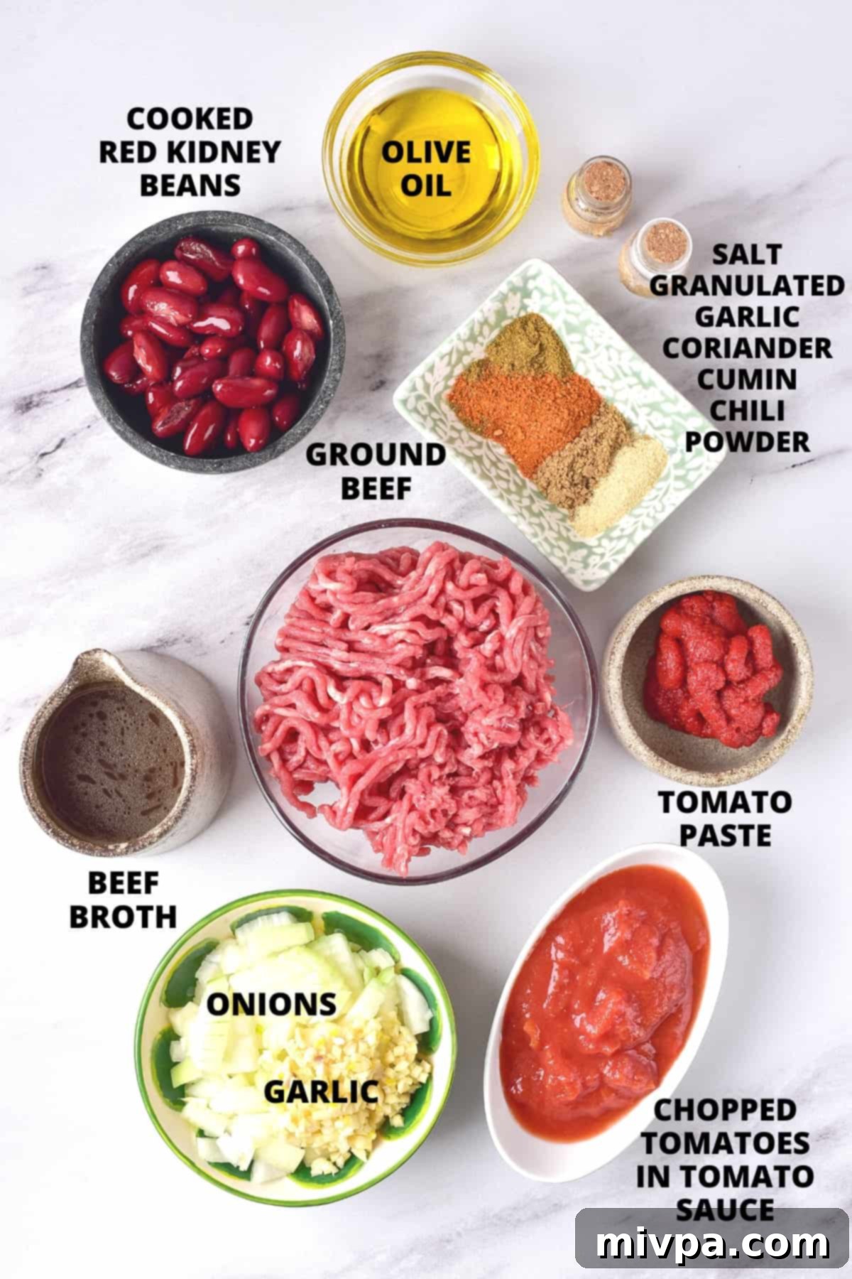 Ingredients for Dutch oven chili recipe laid out on marble board.