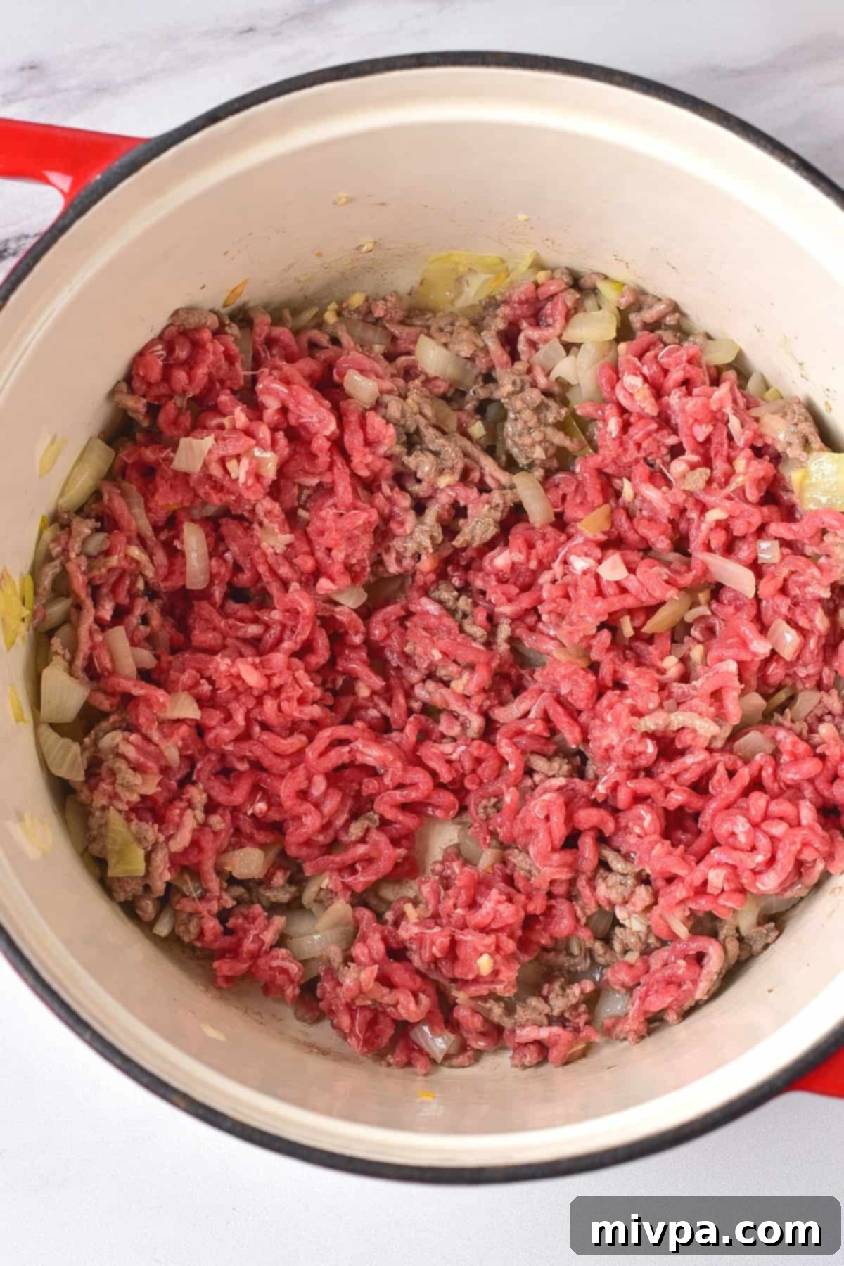 Ground beef in a large Dutch oven.