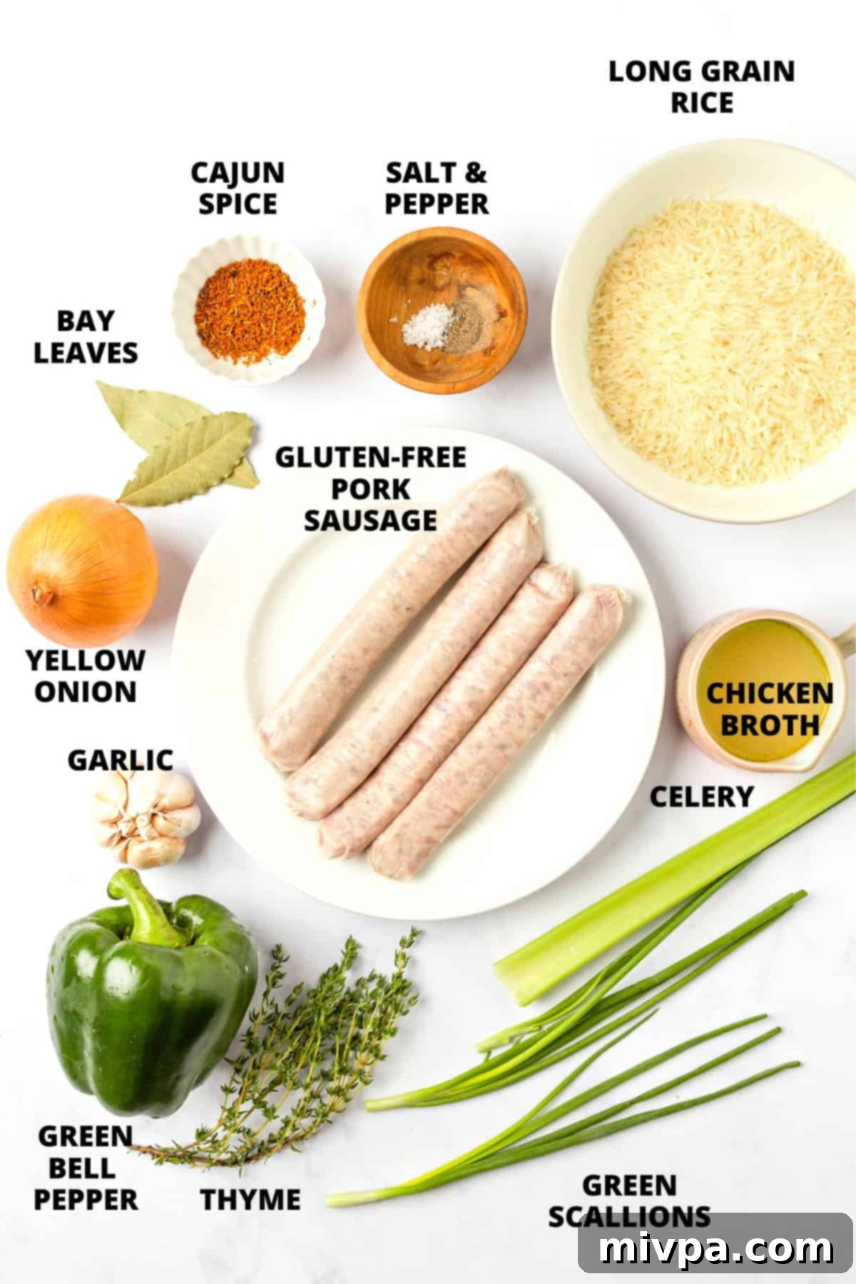 All the fresh ingredients for sausage dirty rice laid out beautifully on a marble board, including sausage, bell peppers, onions, celery, and spices.