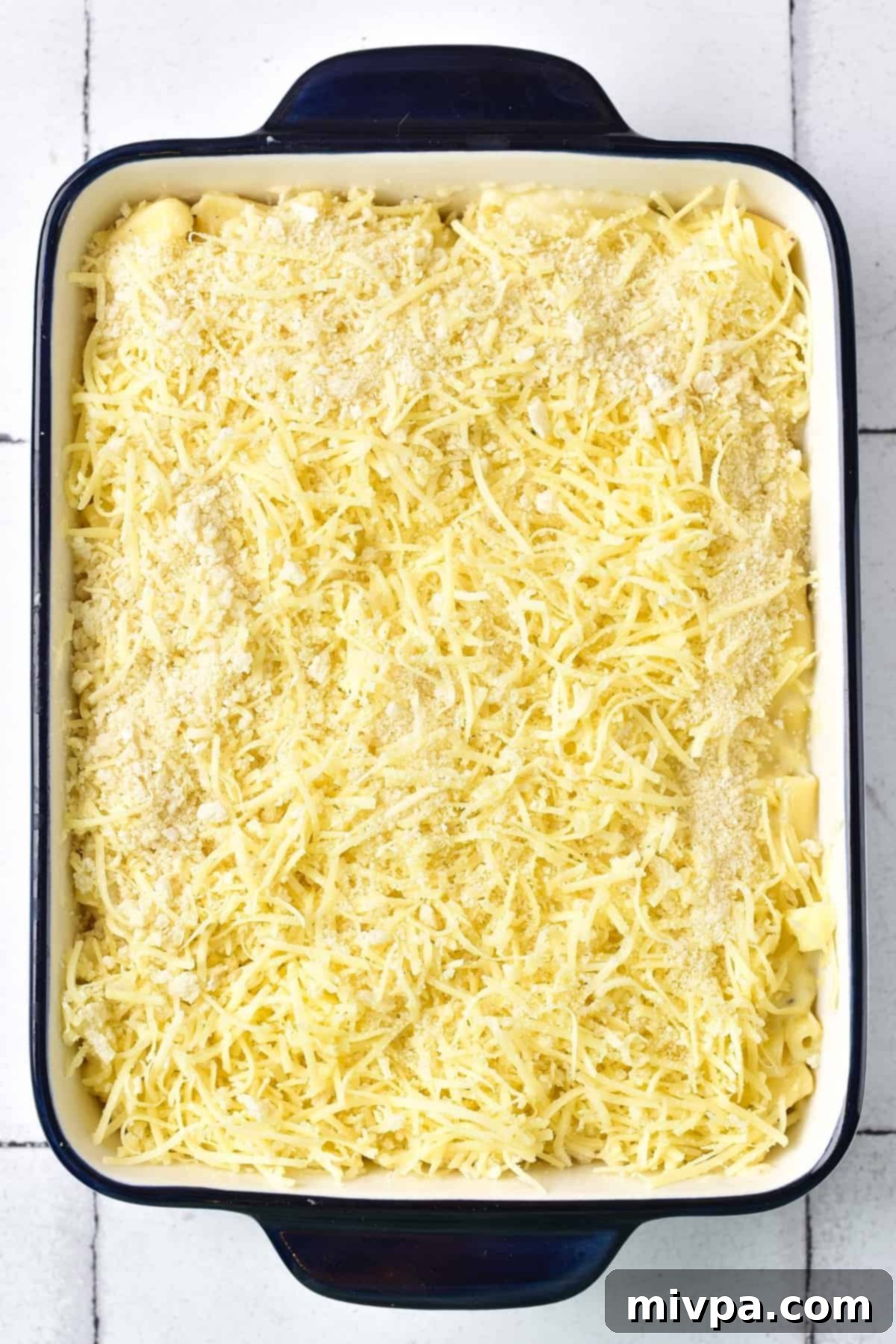 Breadcrumbs and shredded cheese in a casserole dish.